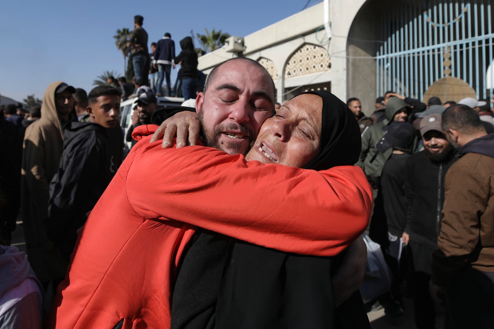 A freed Palestinian prisoner, left, is greeted by a relative as he arrives in the Gaza Strip after being released from an Israeli prison following a ceasefire agreement between Hamas and Israel in Khan Younis, Gaza Strip, Saturday, Feb. 15, 2025. (AP Photo/Jehad Alshrafi)