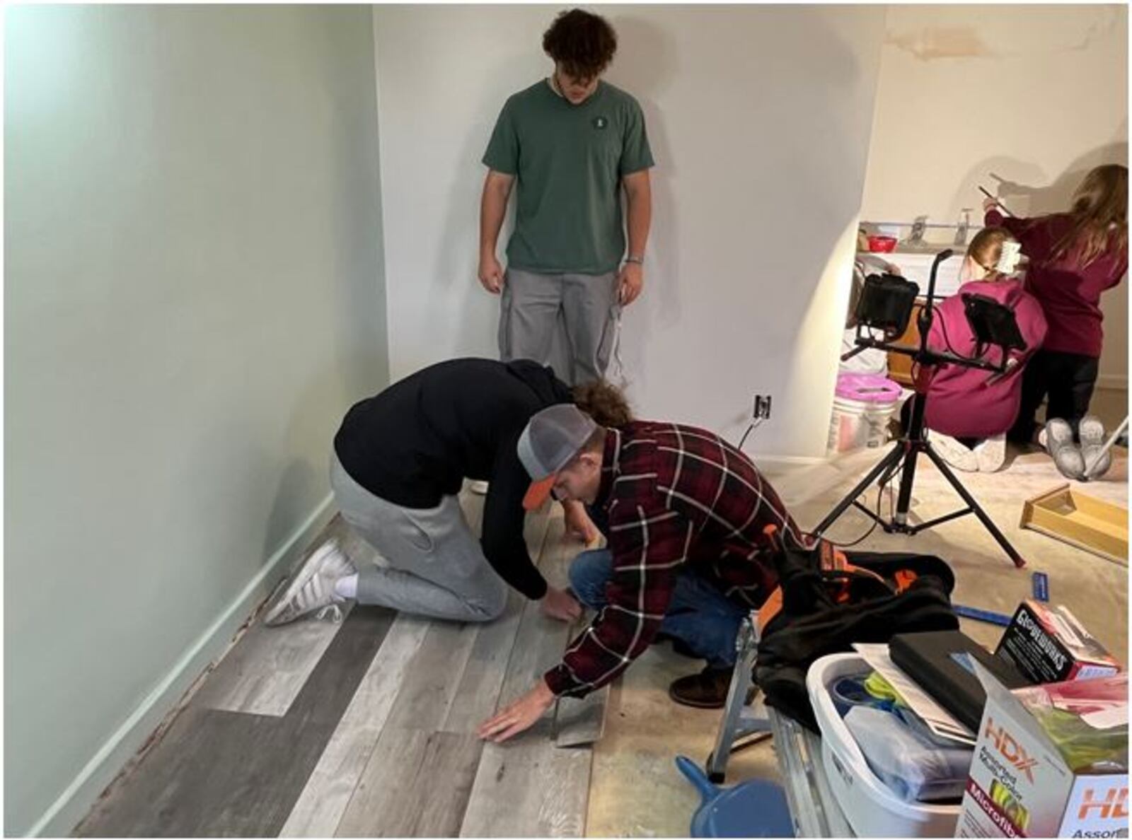 The Service Experience class at Lebanon High School are working to renovate a former motel room into a shelter for homeless families. Students were installing flooring and painting furniture. ED RICHTER/STAFF