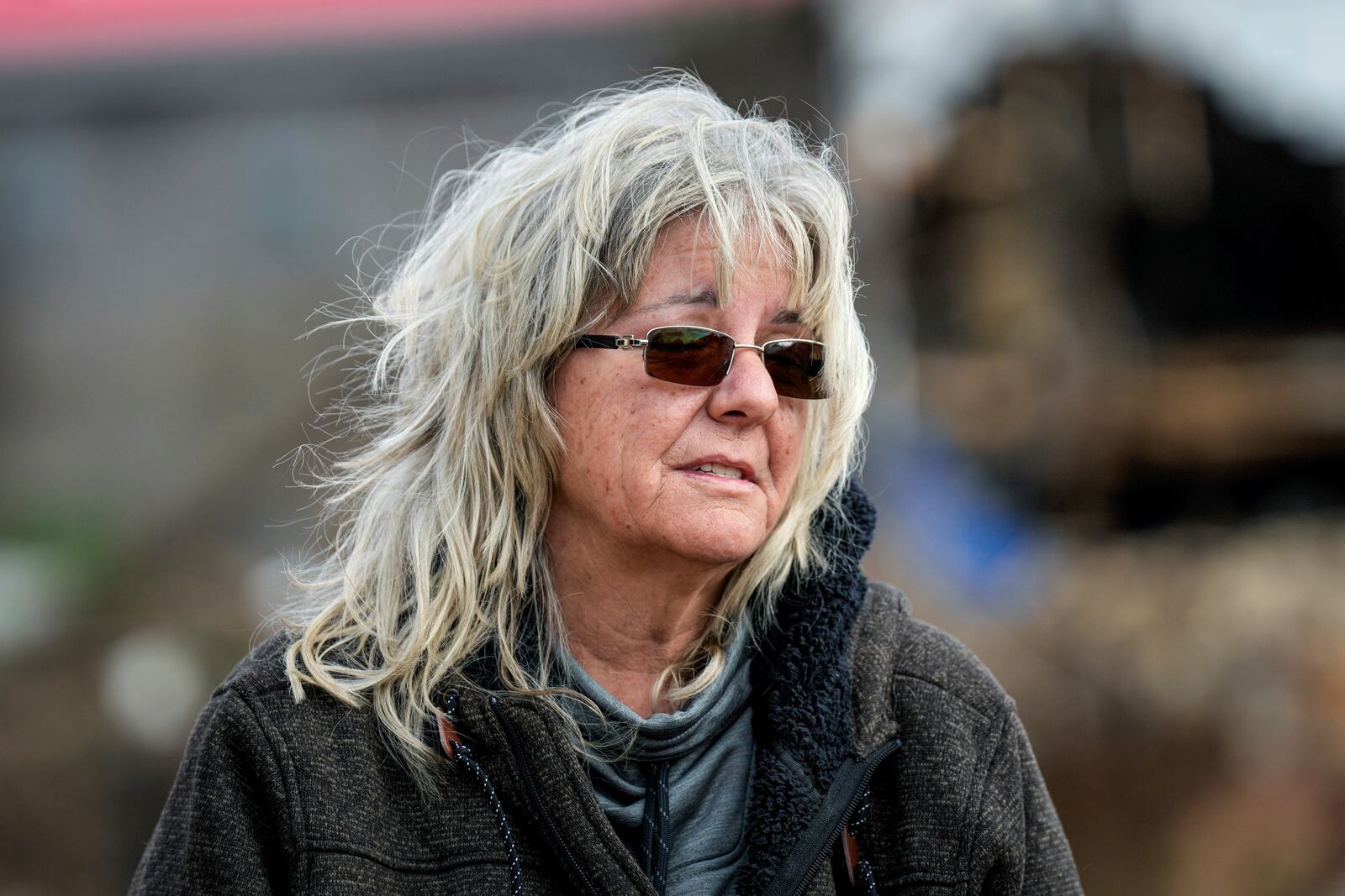 Vickie Revis stands outside her trailer on her property where she's currently living after her home was destroyed by Hurricane Helene, Wednesday, Feb. 5, 2025, in Swannanoa, N.C. (AP Photo/Kathy Kmonicek)