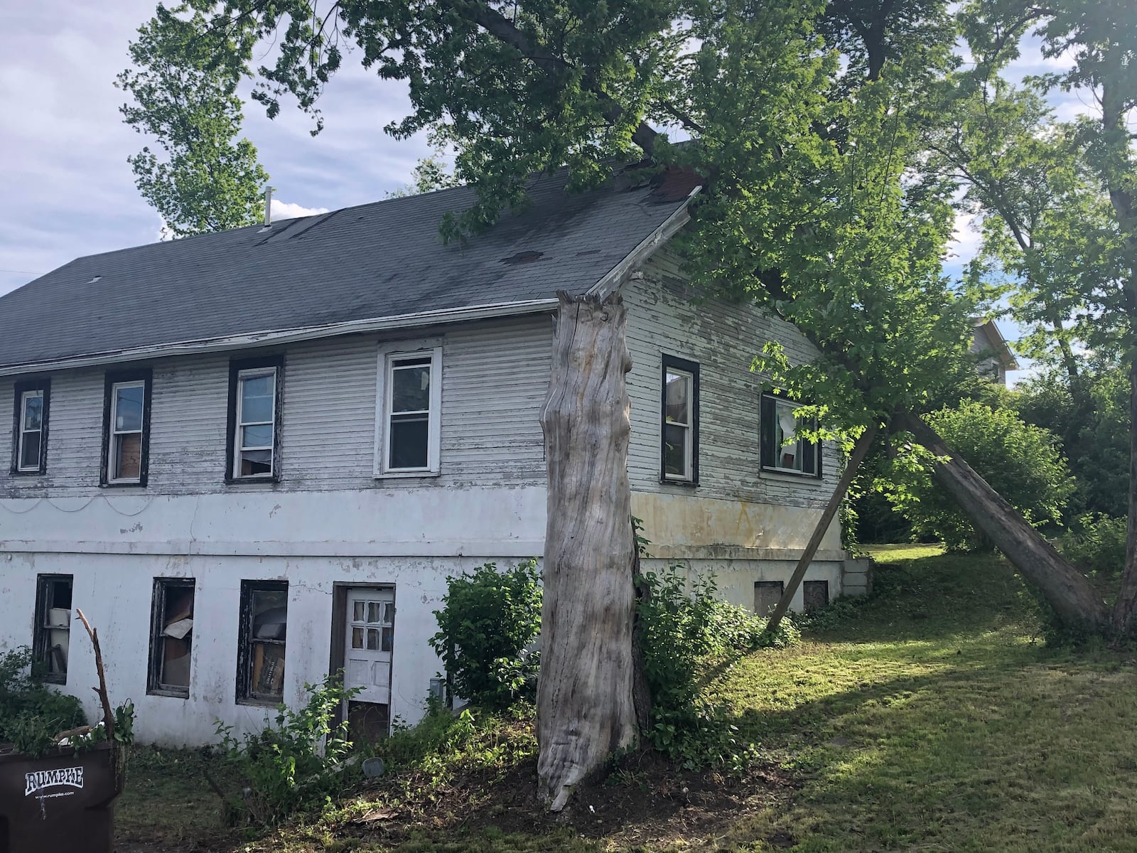 Three years after the 2019 Memorial Day tornadoes, the same tree still pierces the roof of a home on Maplegrove Drive in Harrison Twp. JEREMY P. KELLEY / STAFF