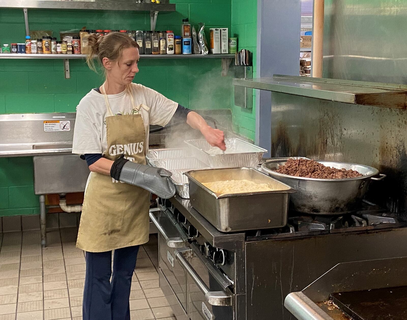 Taraisa Fecke, director of food services at the House of Bread, prepares lunch Thursday afternoon. She plans the non-profit organization’s meals. ISMAIL TURAY JR./STAFF