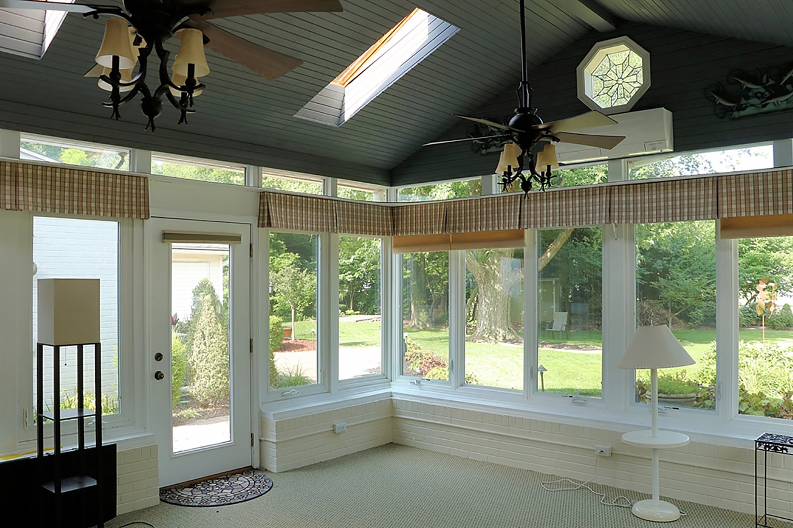 One of the home’s two 4-season room offers views of the landscaped back yard. CONTRIBUTED PHOTO BY KATHY TYLER