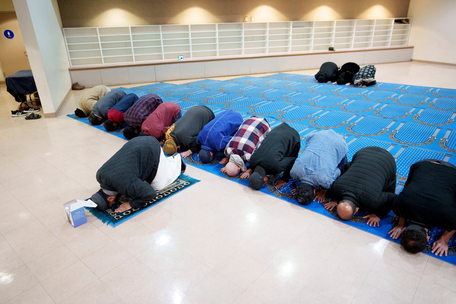 People pray during a community gathering to discuss plans for Ramadan for members of the Masjid Al-Taqwa whose place of worship was gutted in the Eaton fire. They met at a school in Pasadena, California, Saturday, Feb. 15, 2025. (AP Photo/Eric Thayer)