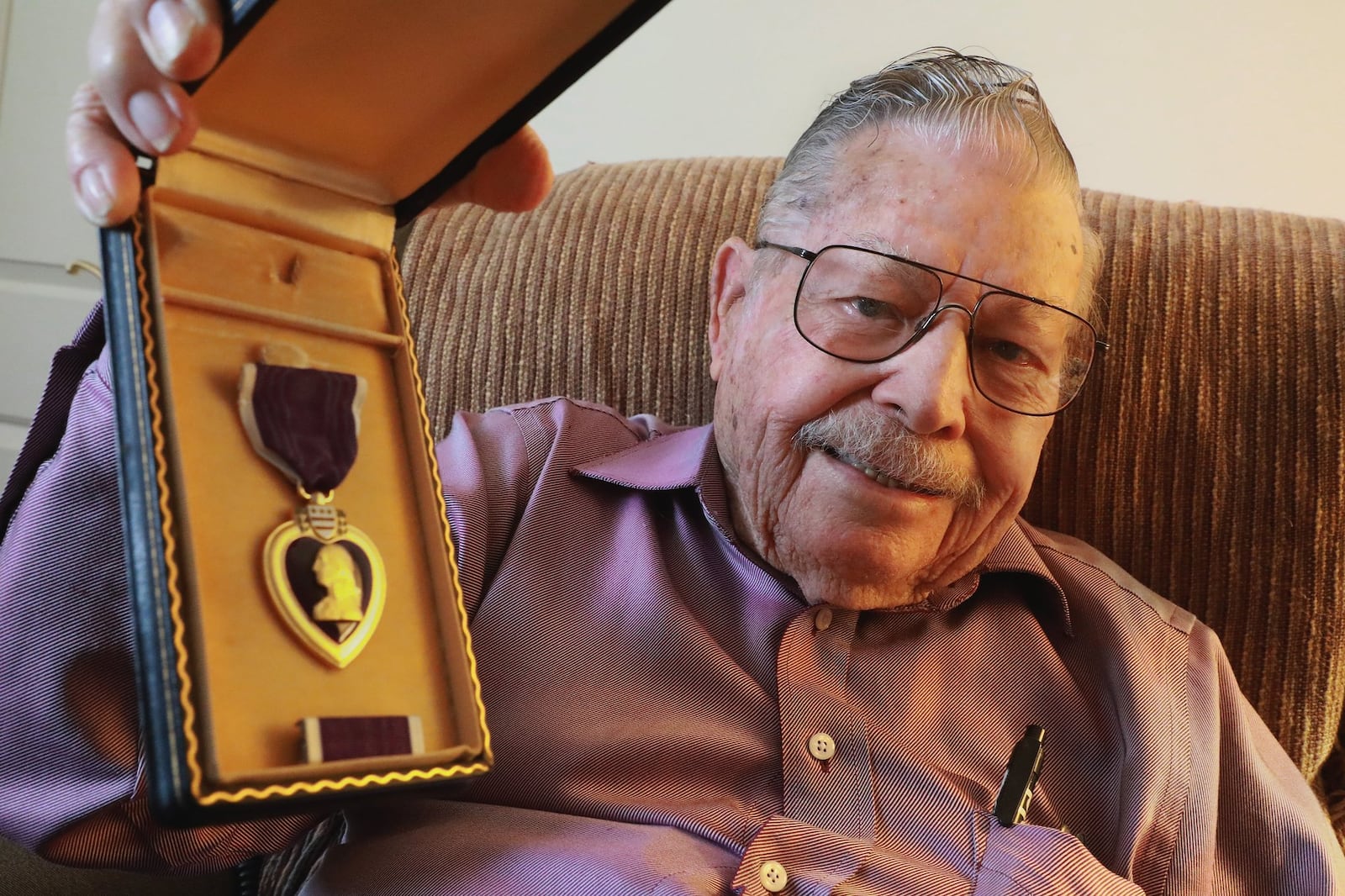 D-Day veteran Albert Carr is very proud of the Purple Heart medal he received during WWII. Carr was shot twice during he service in the war. BILL LACKEY/STAFF