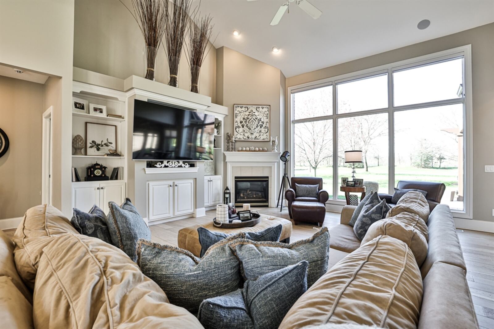 Formal entry opens into an open-concept floor plan with the great room, dining room and foyer all creating a versatile living space. Tucked into one corner of the great room is a gas fireplace with wood mantel surround and another wall has a built-in media center. CONTRIBUTED PHOTO BY KATHY TYLER