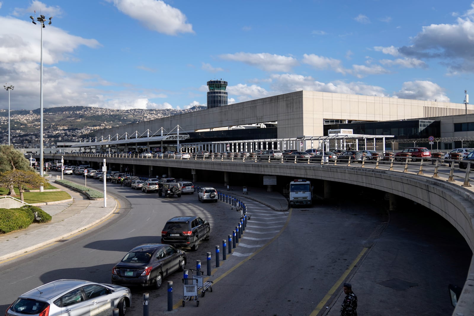 Cars pass by the terminal of Rafik Hariri International Airport, in Beirut, Lebanon, Friday, Feb. 21, 2025. (AP Photo/Bilal Hussein)