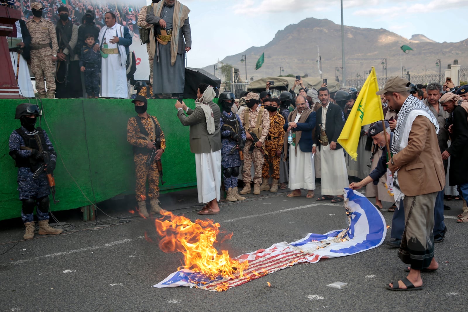 Houthi supporters burn American and Israeli flags during an Anti- U.S and Israel rally in Sanaa, Yemen, Friday, Nov. 8, 2024. (AP Photo/Osamah Abdulrahman)