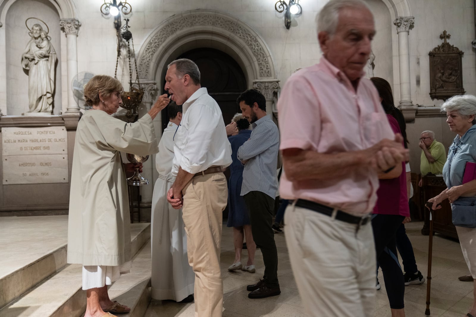 Believers take communion during a Mass for Pope Francis' health in Buenos Aires, Argentina, Wednesday, Feb. 19, 2025. (AP Photo/Rodrigo Abd)