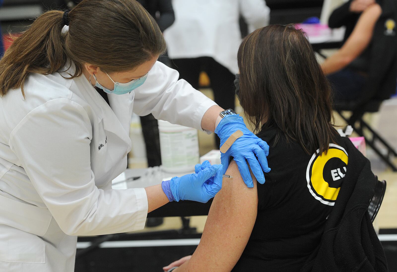 Tammy Drerup, Centerville schools director of student services, receives his first dose of COVID-19 vaccine at Centerville High School, Wednesday, Feb. 3, 2021.