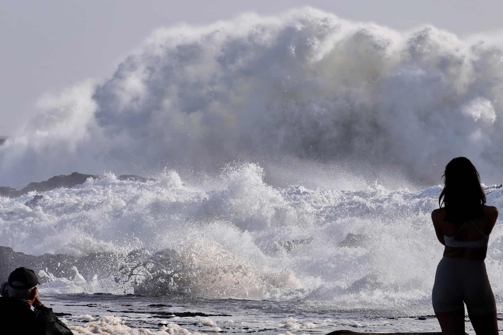 People watch as huge swells hit the beaches on the Gold Coast, Australia, Thursday, March 6, 2025. (Jason O'Brien/AAP Image via AP)