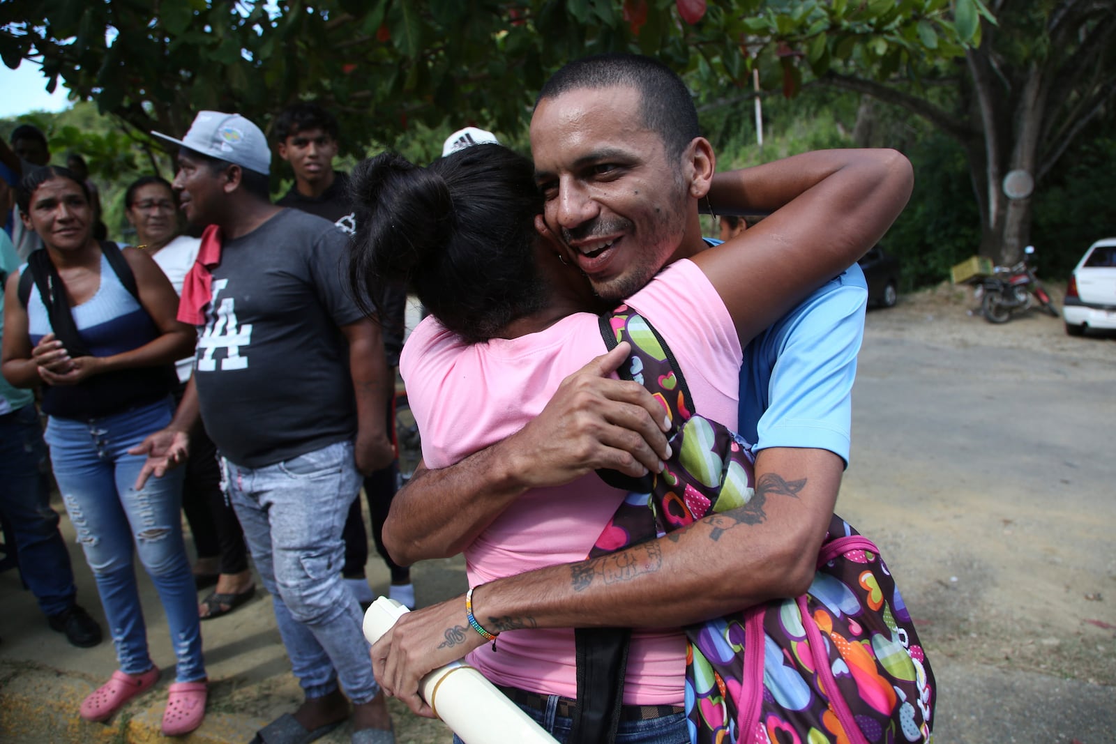 Wilmer Garcia is embraced after his release from the Yare 3 prison, in San Francisco de Yare, Venezuela, Saturday, Nov. 16, 2024. Attorney General Tarek William Saab announced the release of some of those who were detained during a government crackdown following anti-government protests against the results of the presidential election. (AP Photo/Cristian Hernandez)