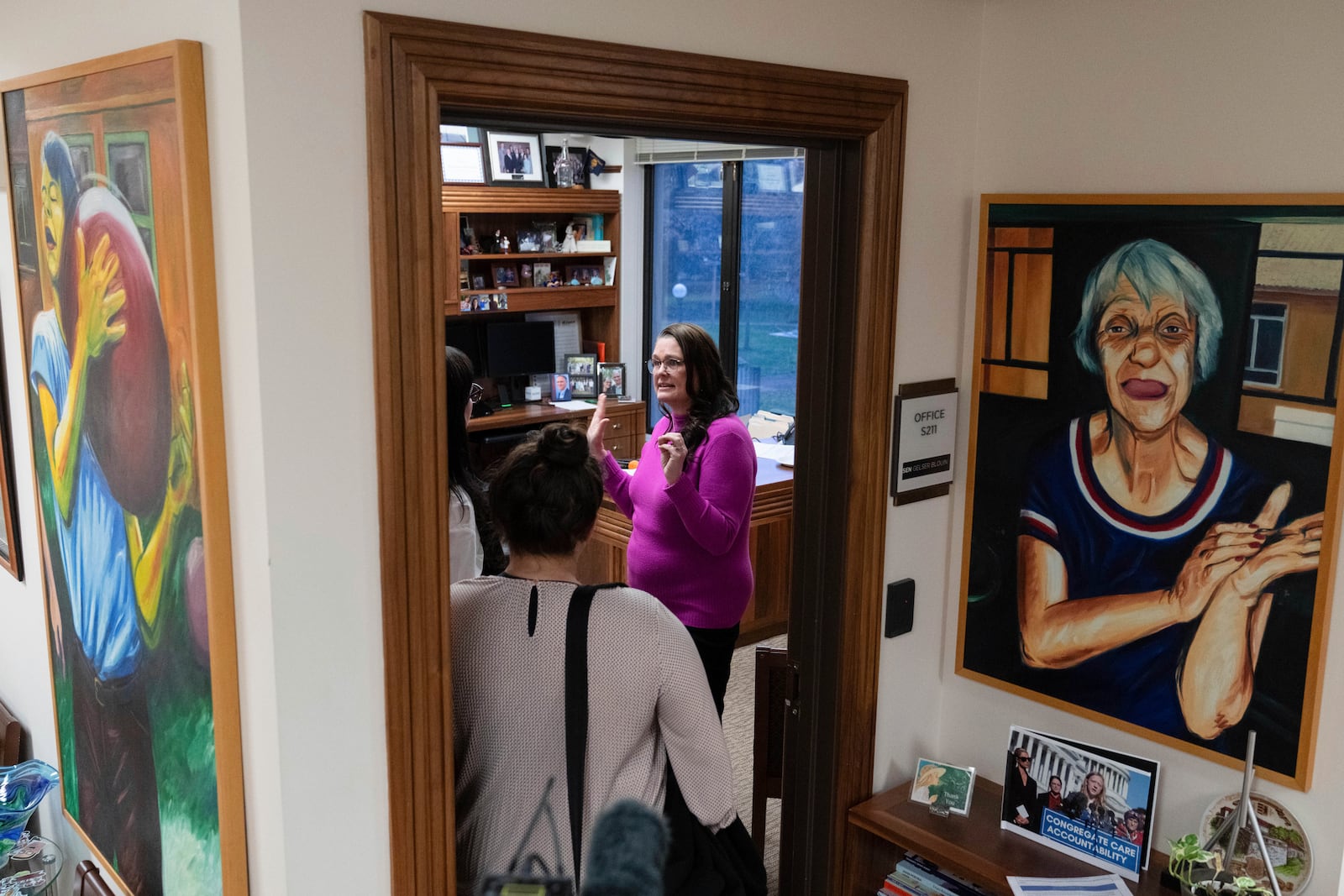 Oregon state Sen. Sara Gelser speaks with people in her office on Wednesday, Dec. 11, 2024, in Salem, Ore. (AP Photo/Jenny Kane)