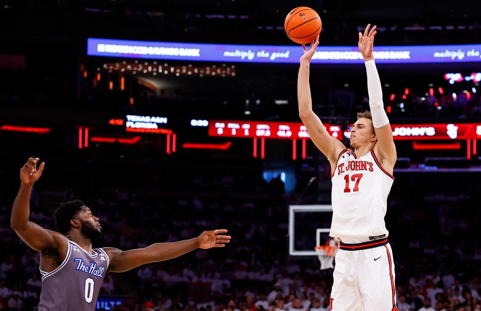 St. John's forward Ruben Prey (17) makes a 3-point shot over Seton Hall guard Dylan Addae-Wusu (0) during the second half of an NCAA college basketball game, Saturday, March 1, 2025, in New York. (AP Photo/Noah K. Murray)