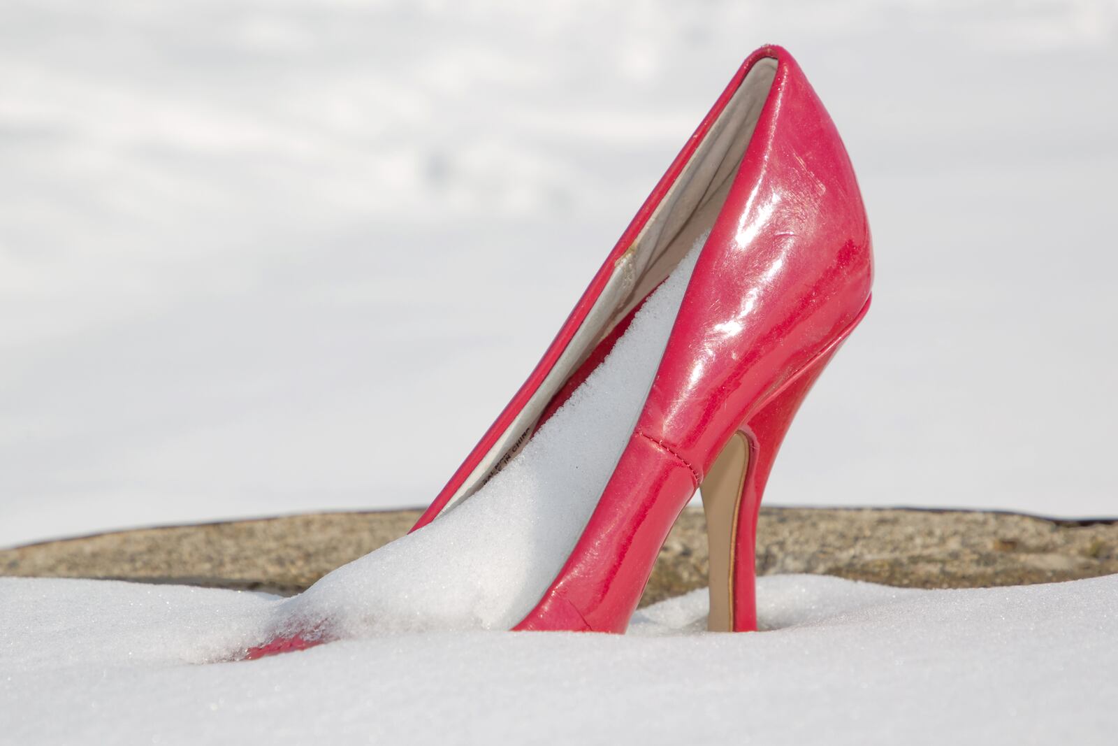 A red high-heeled shoe is seen full of snow in the Oregon District of Dayton Feb. 20, 2021. ADAM ALONZO/CONTRIBUTED