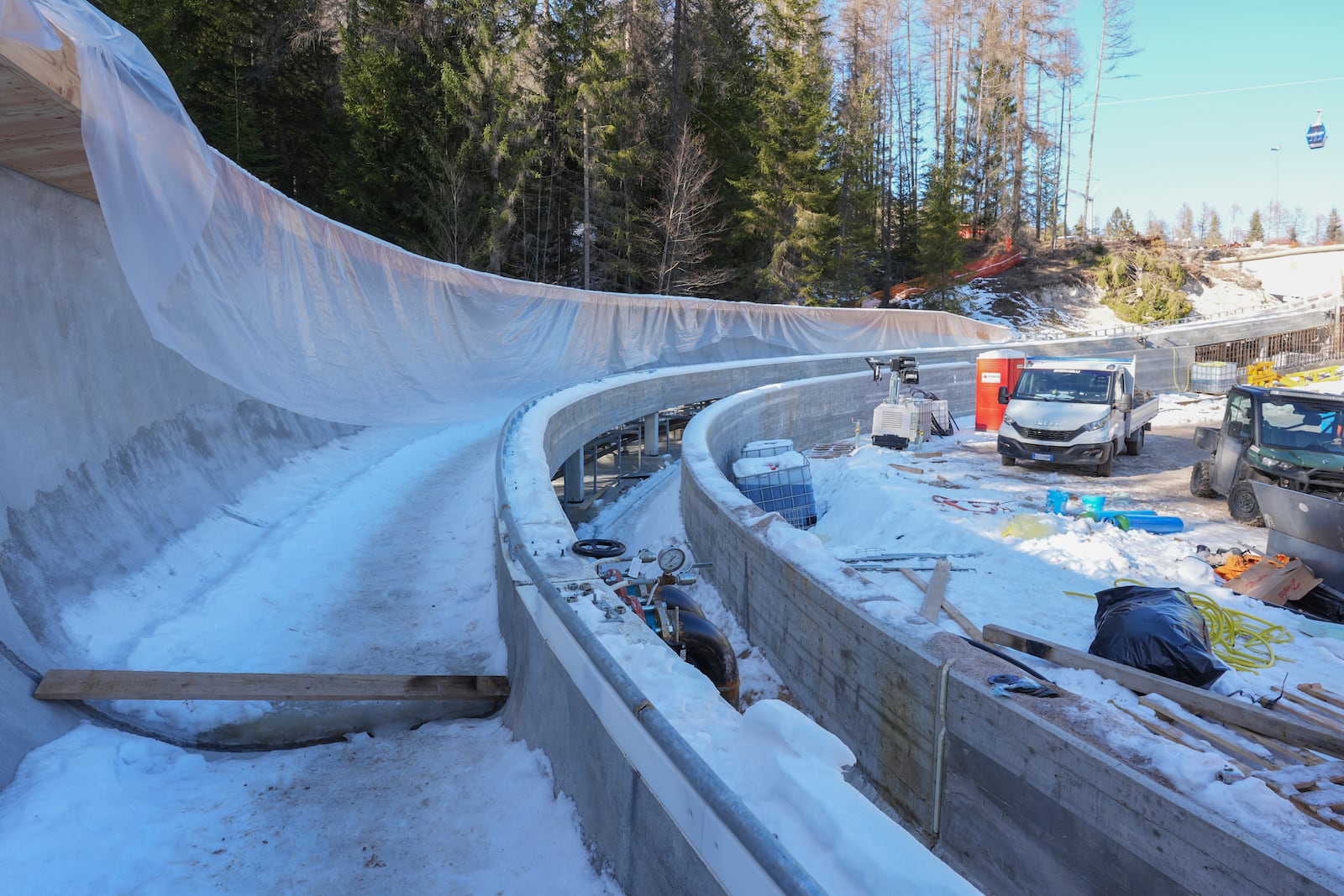 Construction work takes place at the Cortina Sliding Center, venue for the bob, luge and skeleton disciplines at the Milan Cortina 2026 Winter Olympics, in Cortina d'Ampezzo, Italy, Thursday, Jan. 16, 2025. (AP Photo/Giovanni Auletta)