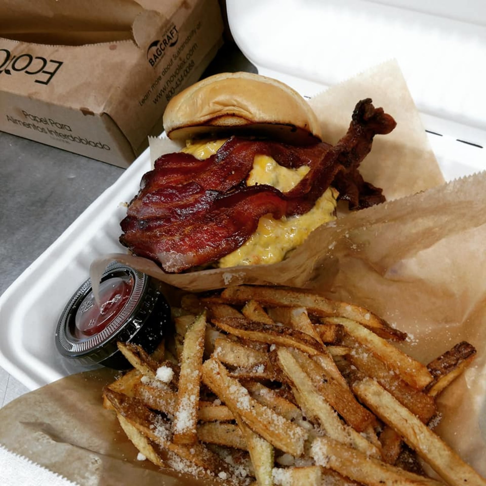 EAT food truck's bacon-topped burger and fries. Source: Facebook