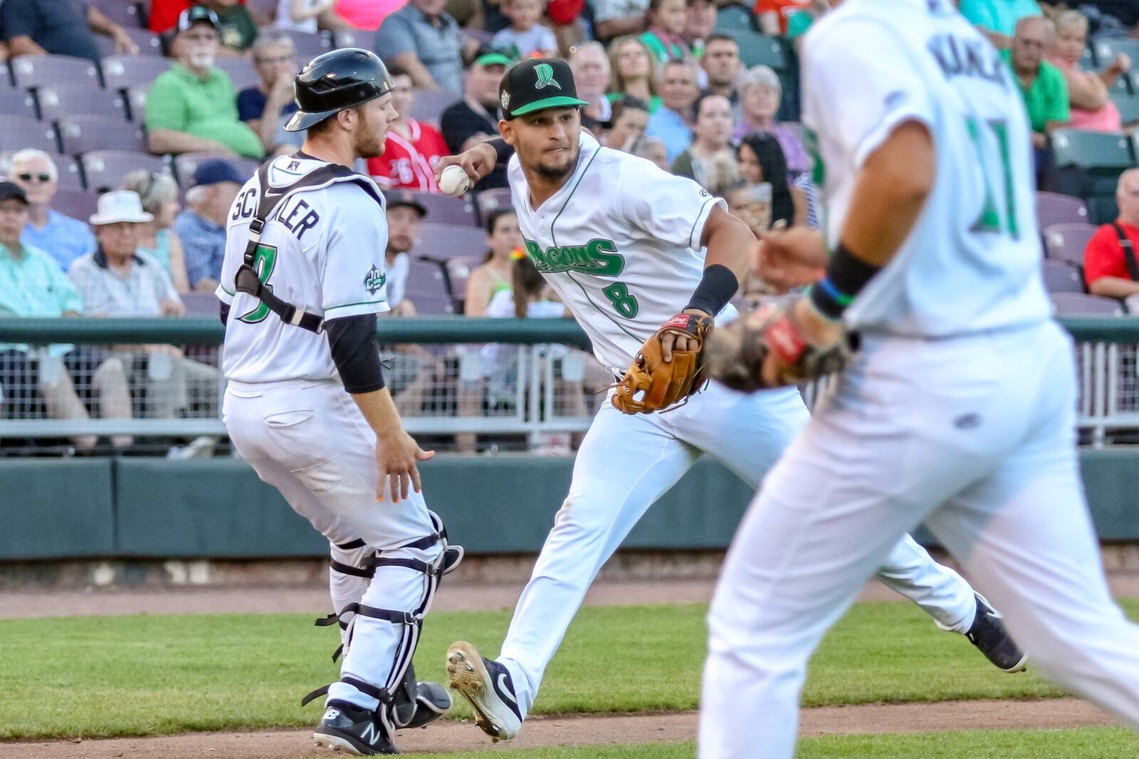 Dayton Dragons third baseman Juan Martinez fields a bunt during their game against the Wisconsin Timber Rattlers on Thursday night at Fifth Third Field. The Timber Rattlers won 1-0. CONTRIBUTED PHOTO BY MICHAEL COOPER