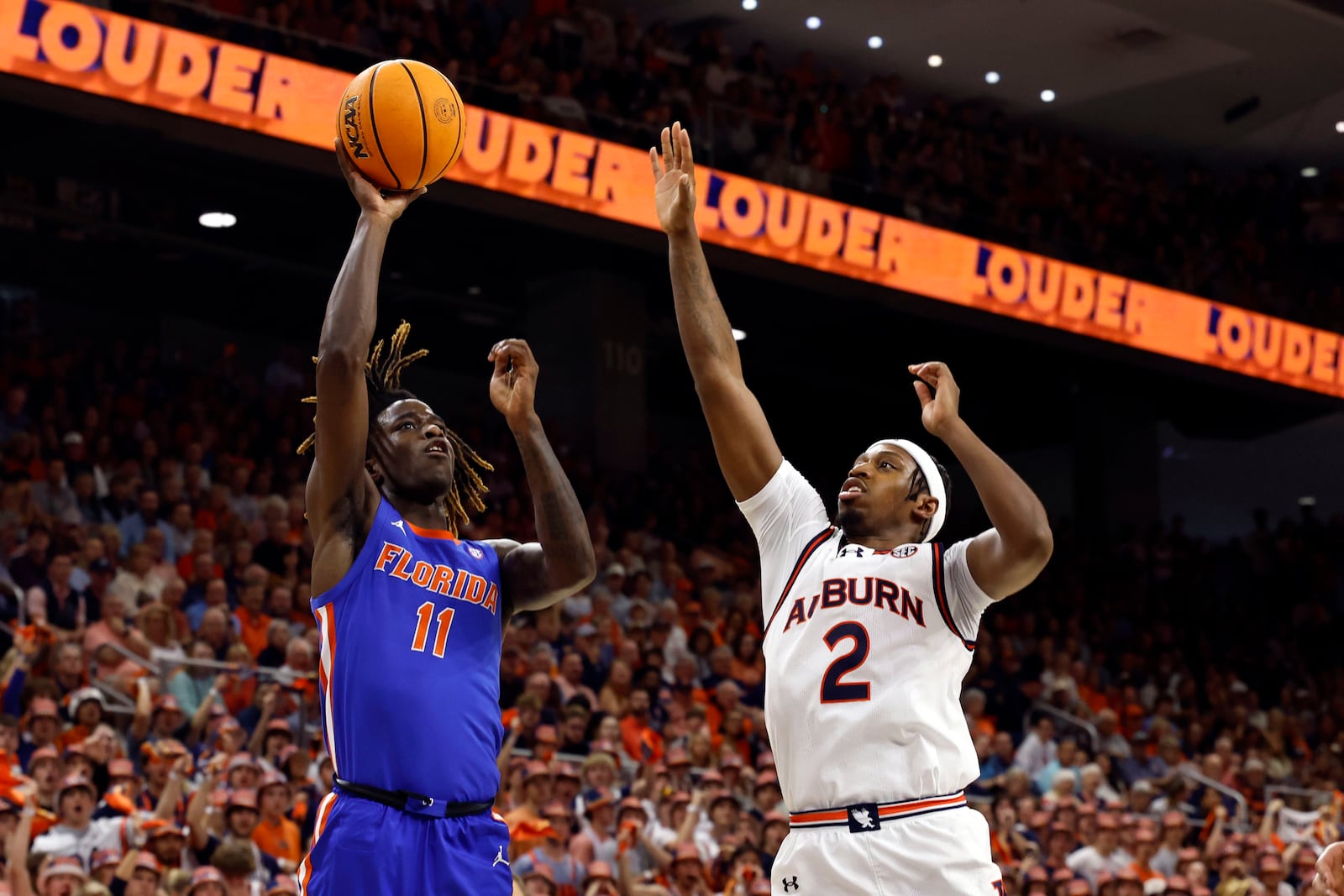 Florida guard Denzel Aberdeen (11) shoots over Auburn guard Denver Jones (2) during the first half of an NCAA college basketball game, Saturday, Feb. 8, 2025, in Auburn, Ala. (AP Photo/Butch Dill)