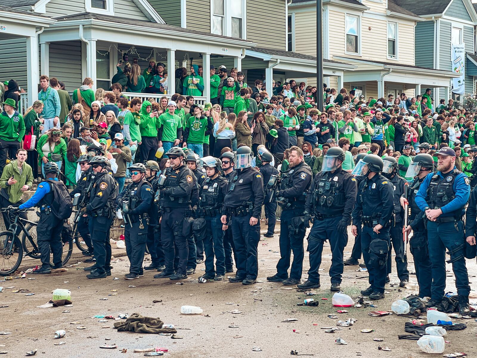 Police officers stand in formation in an attempt to quell a disturbance on Saturday, March 25, 2023, in the University of Dayton campus area. Some people overturned a vehicle, and at least six people were arrested, according to university officials. KEEGAN GUPTA/CONTRIBUTED