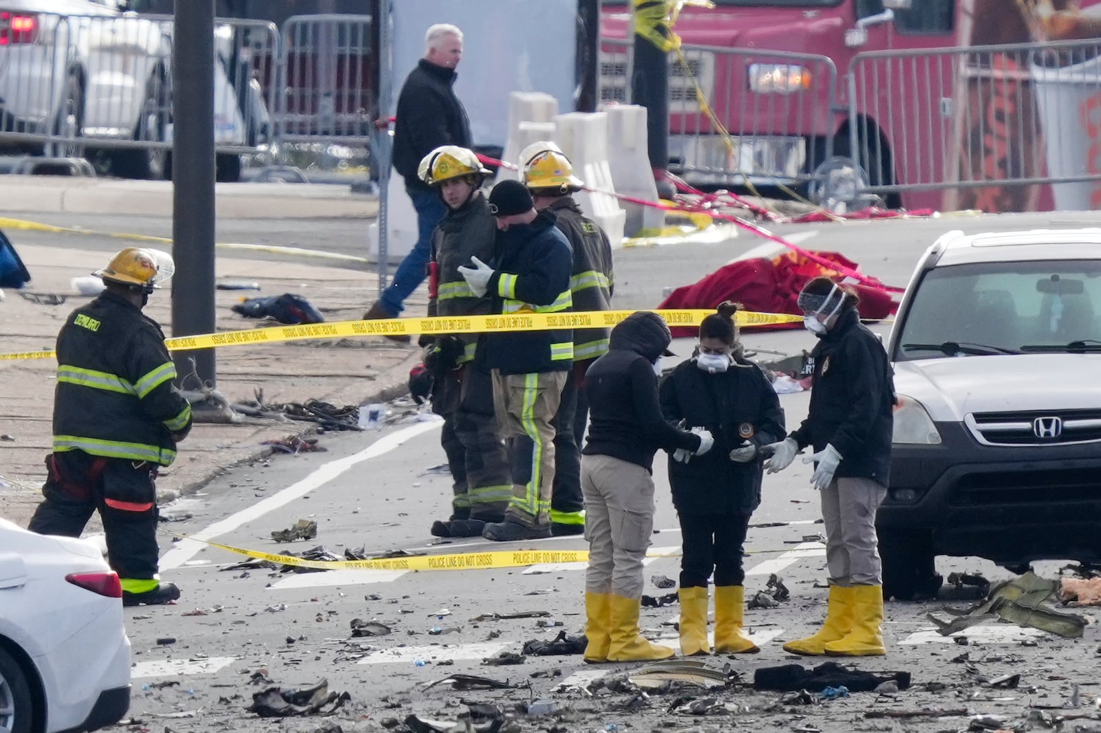 Investigators work the scene after a small plane crashed in Philadelphia, Saturday, Feb. 1, 2025. (AP Photo/Matt Rourke)