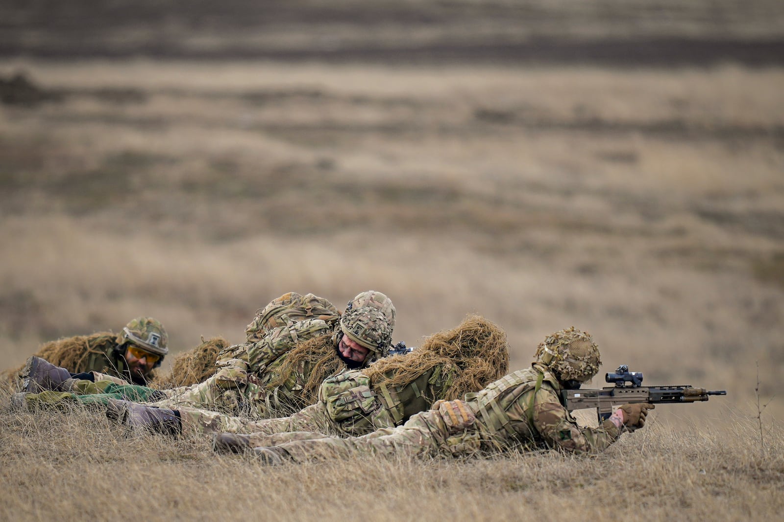 British IRF forces hold a position during the Steadfast Dart 2025 exercise, involving some 10,000 troops in three different countries from nine nations and represent the largest NATO operation planned this year, at a training range in Smardan, eastern Romania, Wednesday, Feb. 19, 2025. (AP Photo/Vadim Ghirda)