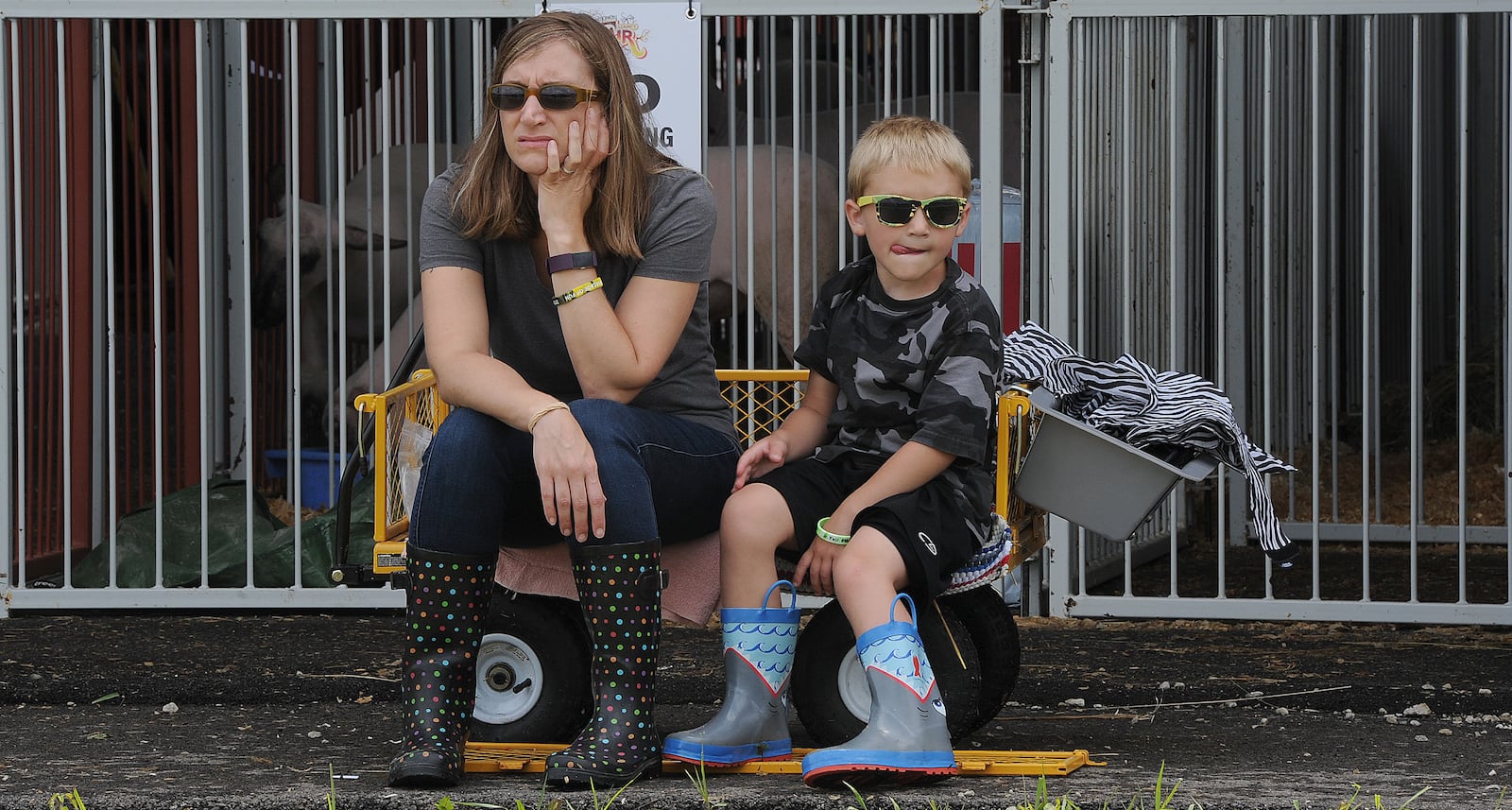 Michelle Neff and her son Oliver, 6, watch the horse show Tuesday July 13, 2021 at the Montgomery County Fair. MARSHALL GORBY\STAFF