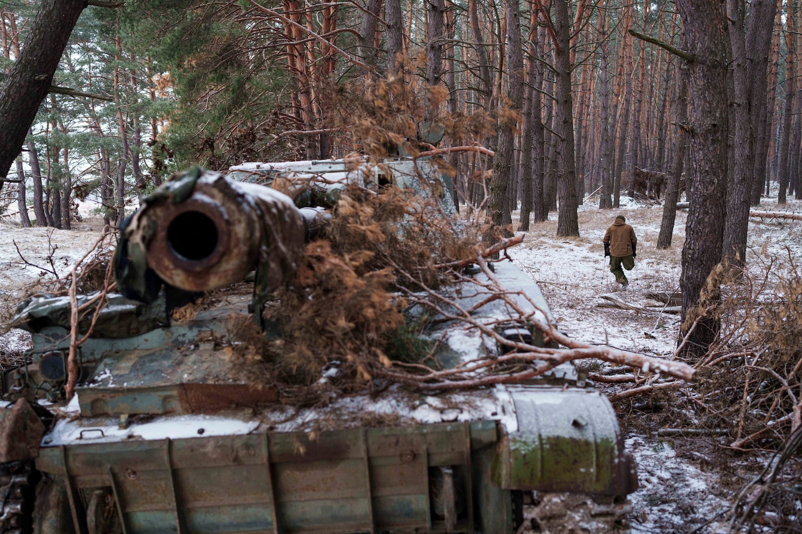 Leonid Lobchuk, a soldier with Ukraine's 127th brigade who lost a leg in combat in eastern Ukraine in 2015, walks near his self-propelled howitzer in Ukraine's Kharkiv region on Feb. 10, 2025. (AP Photo/Evgeniy Maloletka)