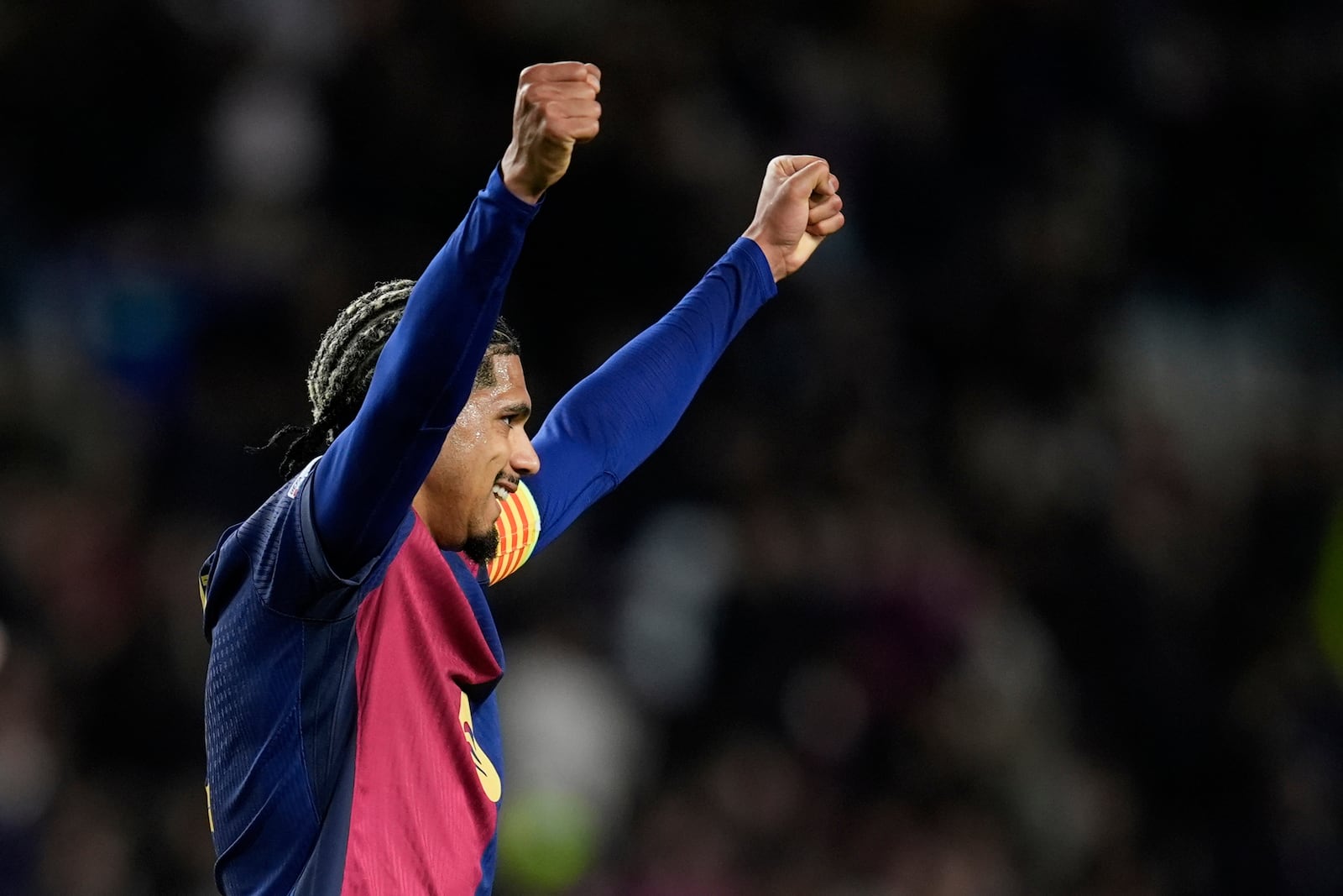 Barcelona's Ronald Araujo celebrates at the end of the Champions League round of 16 second leg soccer match between FC Barcelona and SL Benfica at the Lluis Companys Olympic Stadium in Barcelona, Spain, Tuesday, March 11, 2025. (AP Photo/Emilio Morenatti)