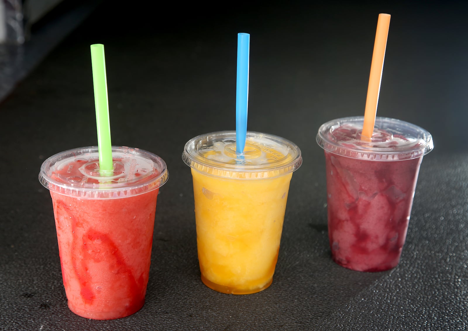 Strawberry Bomb, Peach and Wild Berry smoothies from the Family Bean Coffee Truck. The gourmet coffee truck was founded by Rhonda Hart and her daughters Courtney Smiddy and Tara Heid. The gourmet coffee truck is known for specialty coffees, cold brews, smoothies, frappes and more. LISA POWELL / STAFF. LISA POWELL / STAFF