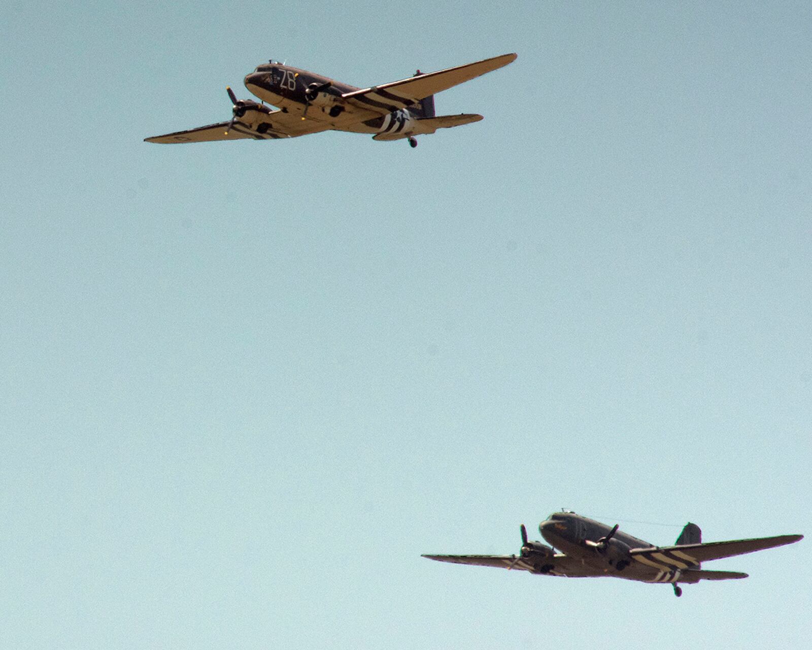 The C-47 Skytrains Tico Belle (top) and Placid Lassie approach their drop zone near the National Museum of the U.S. Air Force on April 27 at Wright-Patterson Air Force Base. The two planes were among those used to drop troops on Normandy for D-Day during World War II. U.S. AIR FORCE PHOTO/R.J. ORIEZ