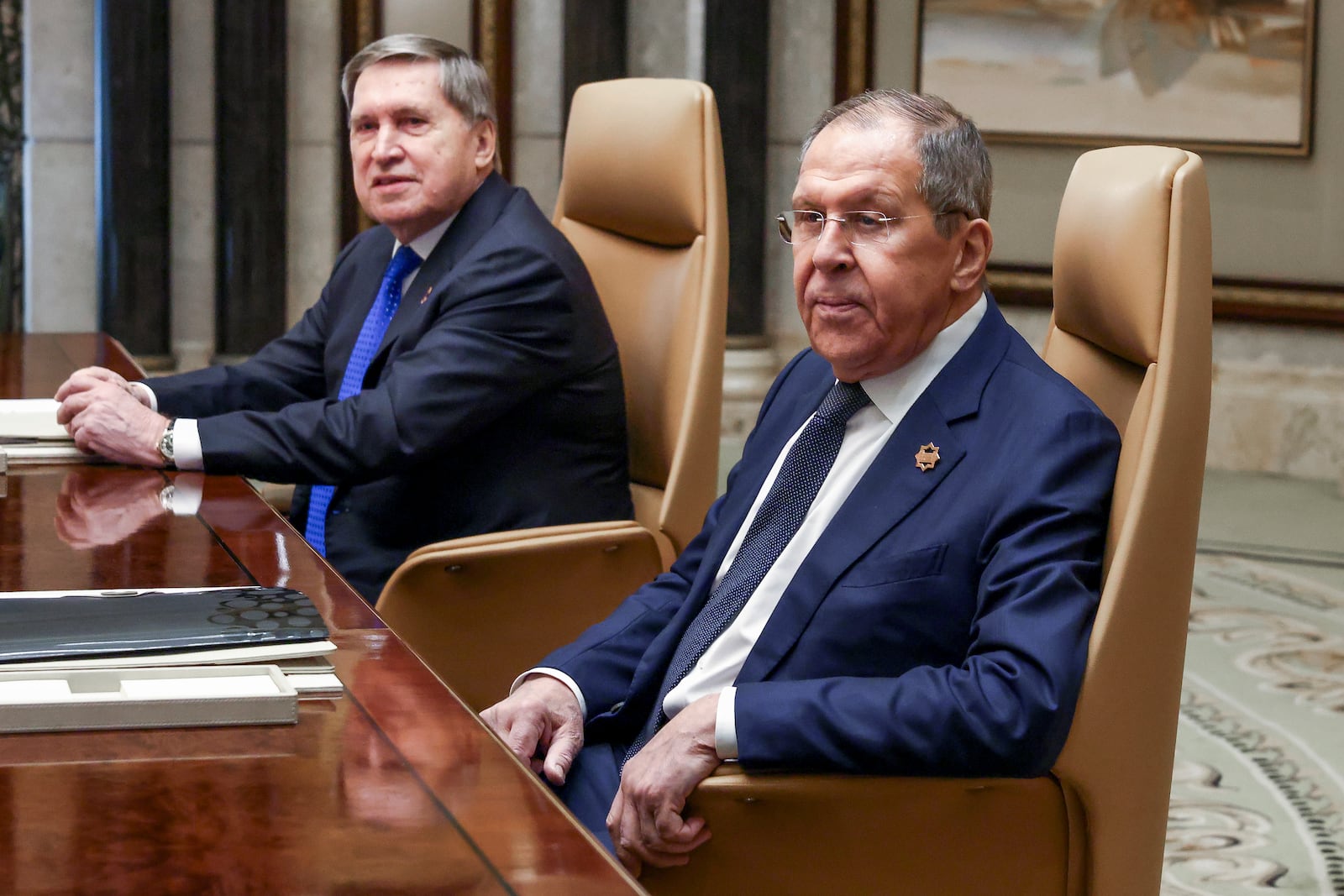 Russian Foreign Minister Sergei Lavrov, right, sits next to Russian President Vladimir Putin's foreign policy advisor Yuri Ushakov during a meeting with U.S. Secretary of State Marco Rubio, U.S. National Security Advisor Mike Waltz and U.S. Middle East envoy Steve Witkoff, Saudi Foreign Minister Prince Faisal bin Farhan Al Saud and Saudi National Security Advisor Mosaad bin Mohammad Al-Aiban, at Diriyah Palace, in Riyadh, Saudi Arabia, Tuesday, Feb. 18, 2025. (Evelyn Hockstein/Pool Photo via AP)