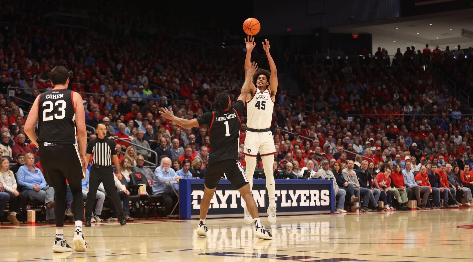 Dayton's Zimi Nwokeji makes a 3-pointer in the first half against Massachusetts on Sunday, Jan. 7, 2024, at UD Arena. David Jablonski/Staff