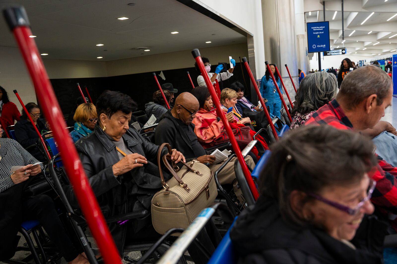 Travelers wait to be wheeled to their gates at Hartsfield-Jackson Atlanta International Airport, Tuesday, Nov. 26, 2024, in Atlanta. (AP Photo/Olivia Bowdoin)