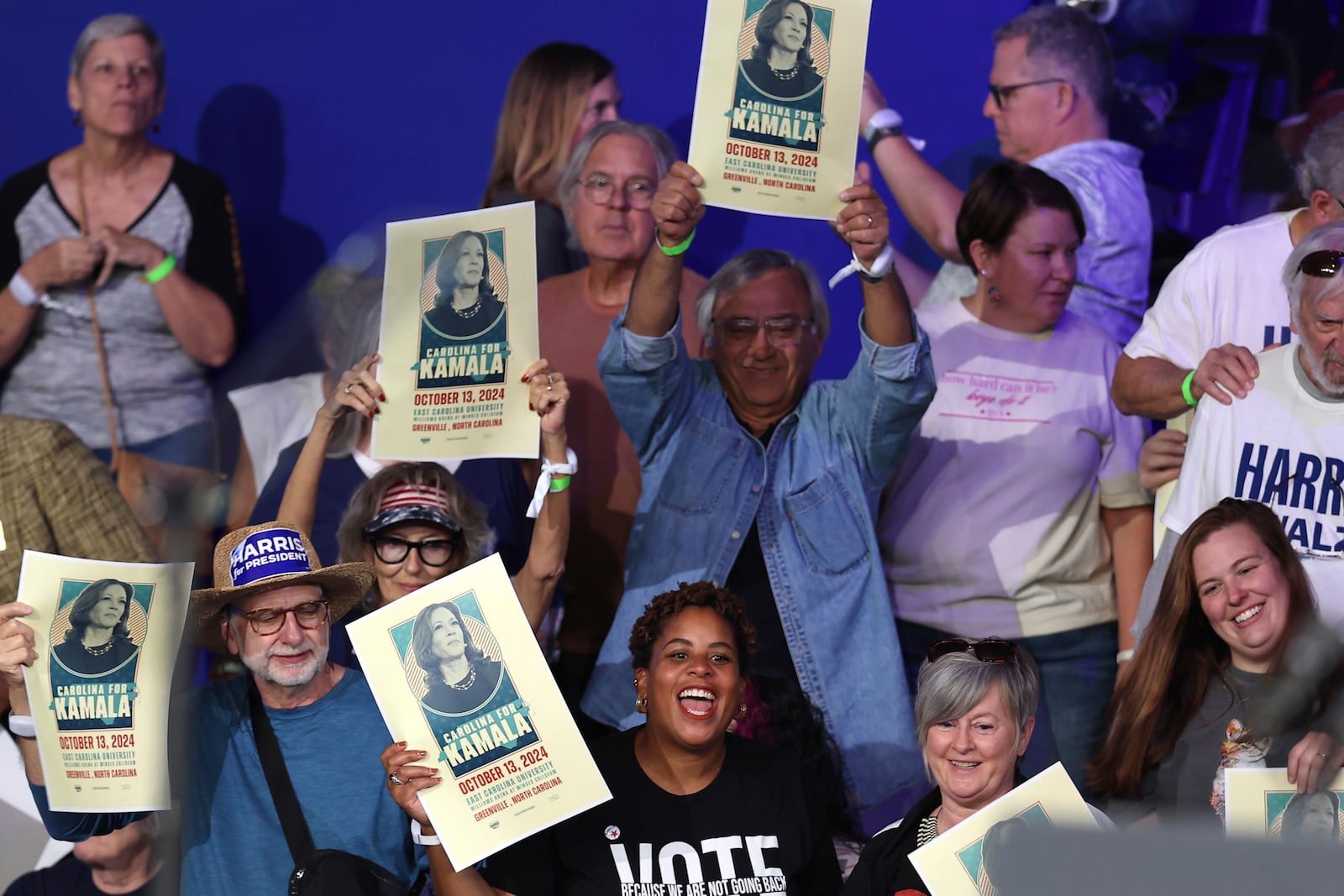 Attendees cheer before Democratic presidential nominee Vice President Kamala Harris arrives to speak during a campaign event at the Minges Coliseum, Sunday, Oct. 13, 2024, in Greenville, N.C. (AP Photo/David Yeazell)