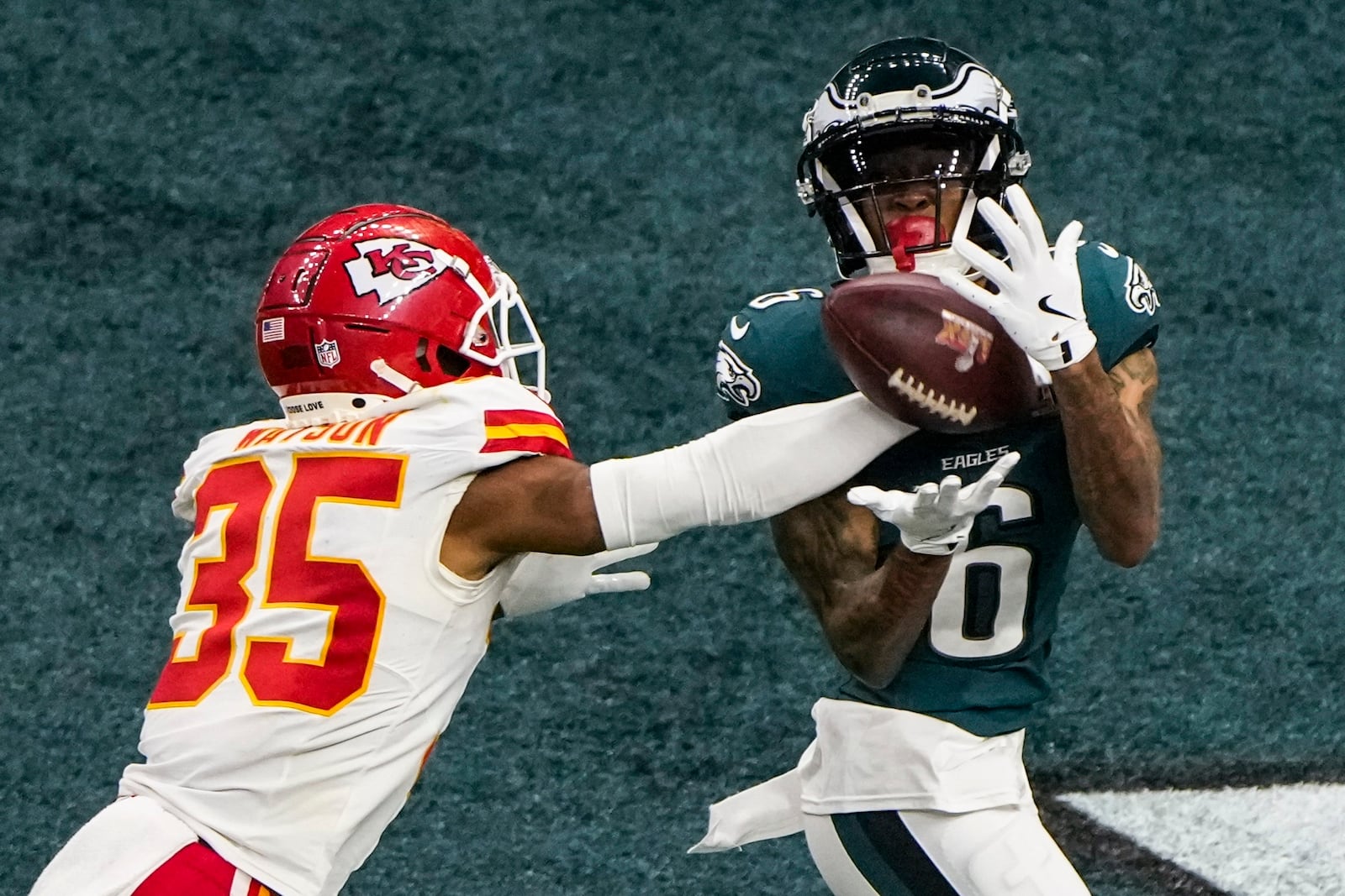 Philadelphia Eagles wide receiver DeVonta Smith (6) catches a touchdown pass ahead of Kansas City Chiefs cornerback Jaylen Watson (35) during the second half of the NFL Super Bowl 59 football game, Sunday, Feb. 9, 2025, in New Orleans. (AP Photo/Charlie Riedel)