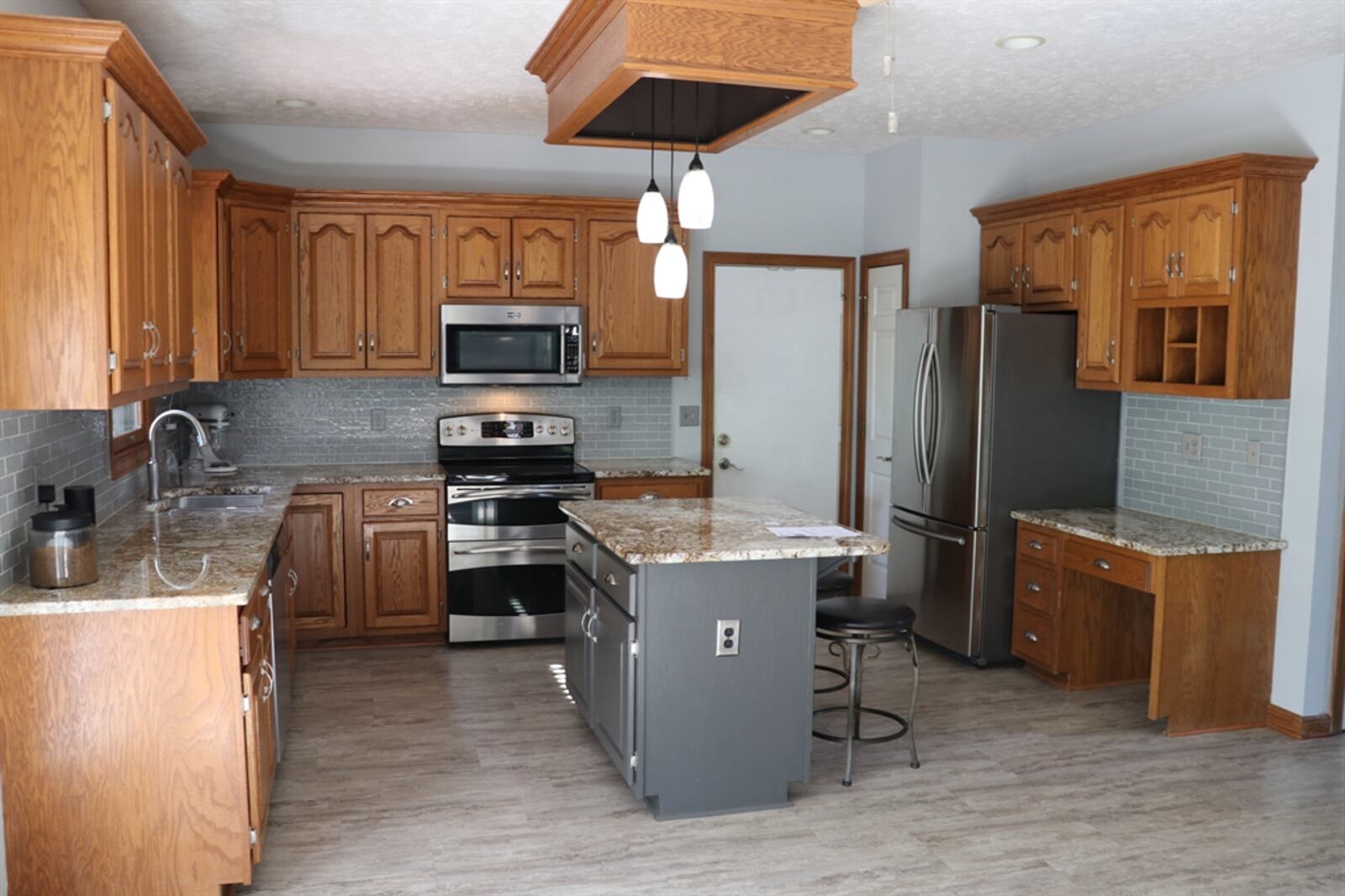 The kitchen features a planning area with space for a coffee station and there is a small pantry closet.