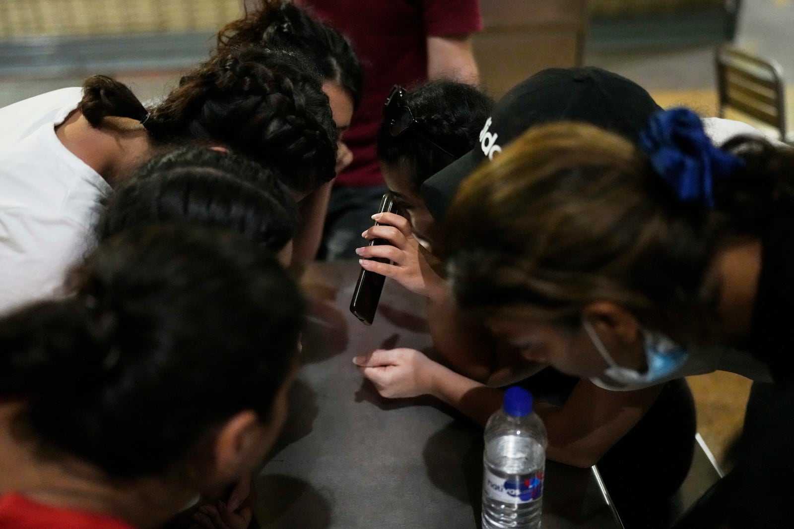 Iranian migrants make a phone call from a bus station food court after arriving in Panama City, Saturday, March 8, 2025, following weeks in a Panamanian immigration camp where they were held after their deportation from the U.S. and released on the condition that they leave the country within 30 days. (AP Photo/Matias Delacroix)