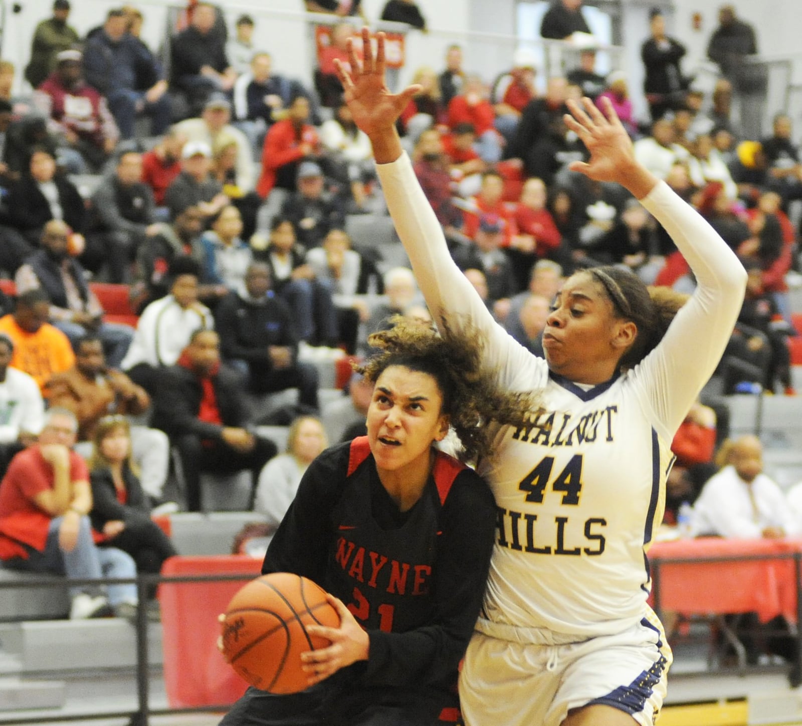 Destiny Bohanon of Wayne (with ball) ducks under Kennedi Myles. Cincinnati Walnut Hills defeated Wayne 58-49 in a girls high school basketball D-I district final at Princeton on Saturday, March 2, 2019. MARC PENDLETON / STAFF