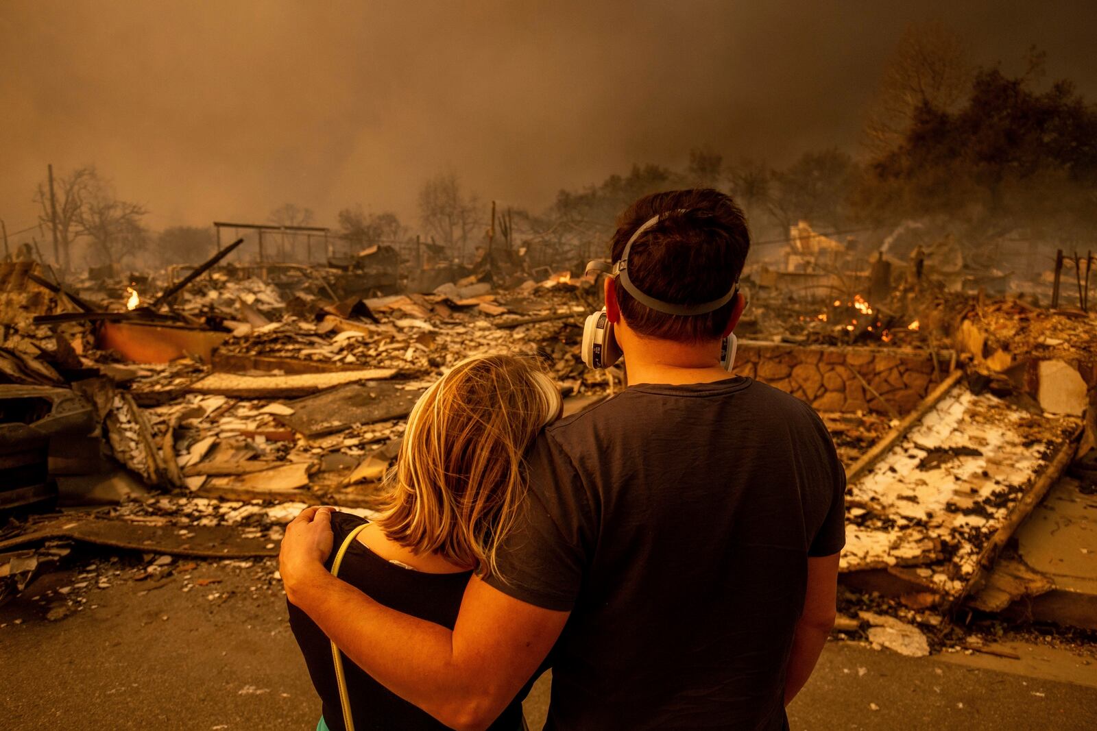 FILE - Megan Mantia, left, and her boyfriend Thomas, only first game given, return to Mantia's fire-damaged home after the Eaton Fire swept through the area, Wednesday, Jan. 8, 2025, in Altadena, Calif. (AP Photo/Ethan Swope, File)