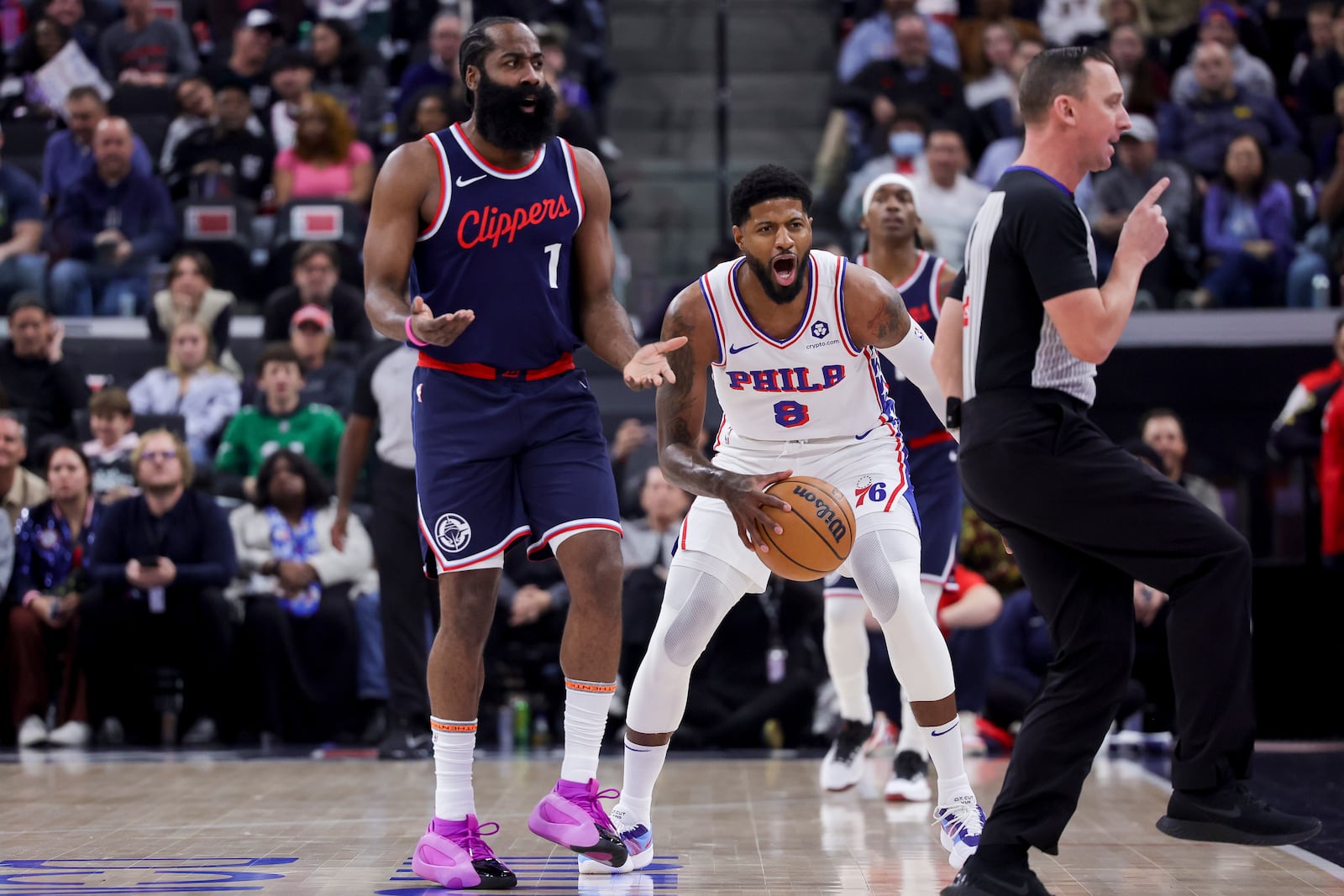 Philadelphia 76ers forward Paul George (8) and Los Angeles Clippers guard James Harden (1) react after a call during the first half of an NBA basketball game, Wednesday, Nov. 6, 2024, in Inglewood, Calif. (AP Photo/Ryan Sun)