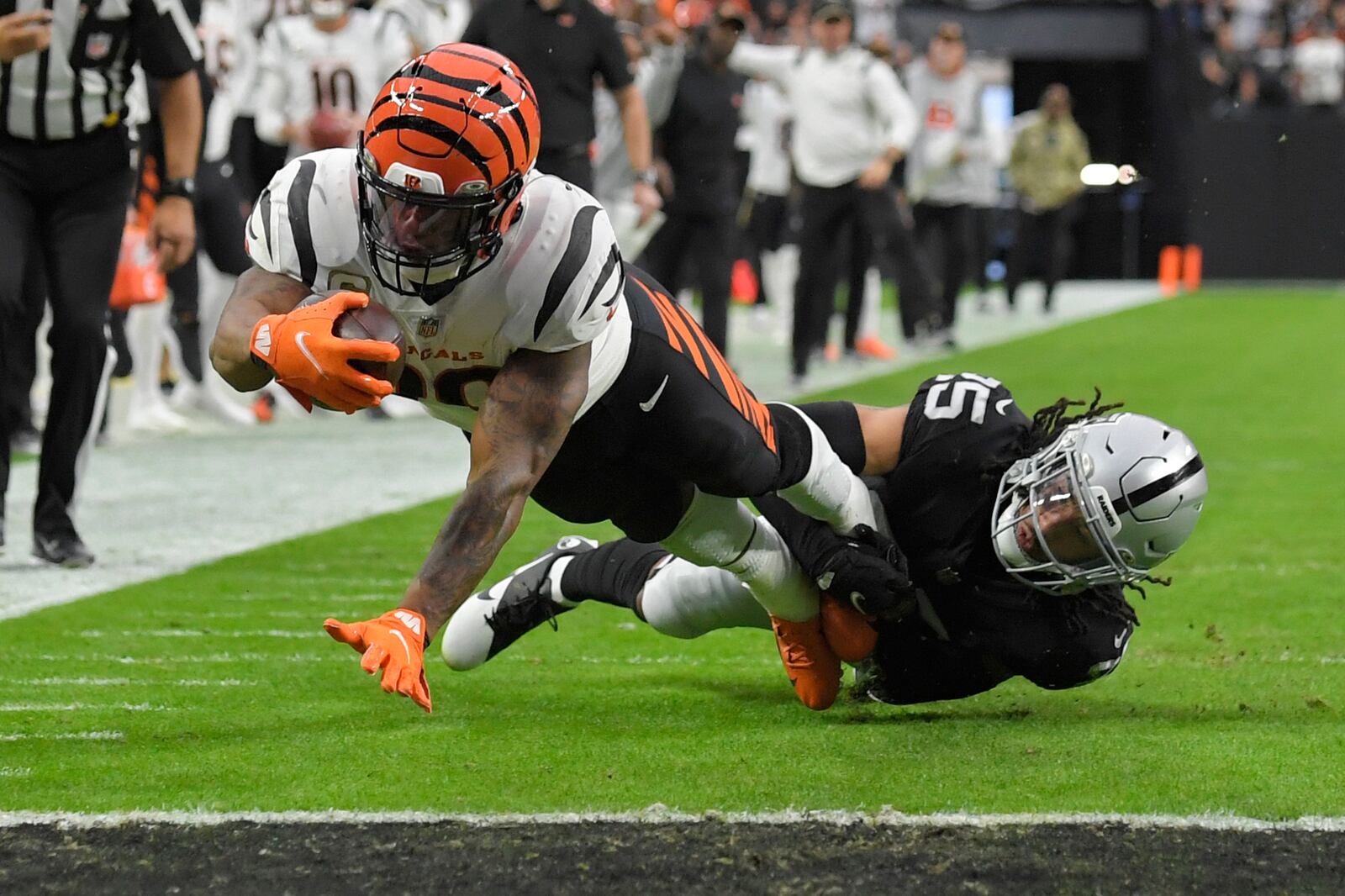 Cincinnati Bengals running back Joe Mixon (28) dives into the endzone for a touchdown against Las Vegas Raiders free safety Trevon Moehrig (25) during the first half of an NFL football game, Sunday, Nov. 21, 2021, in Las Vegas. (AP Photo/David Becker)