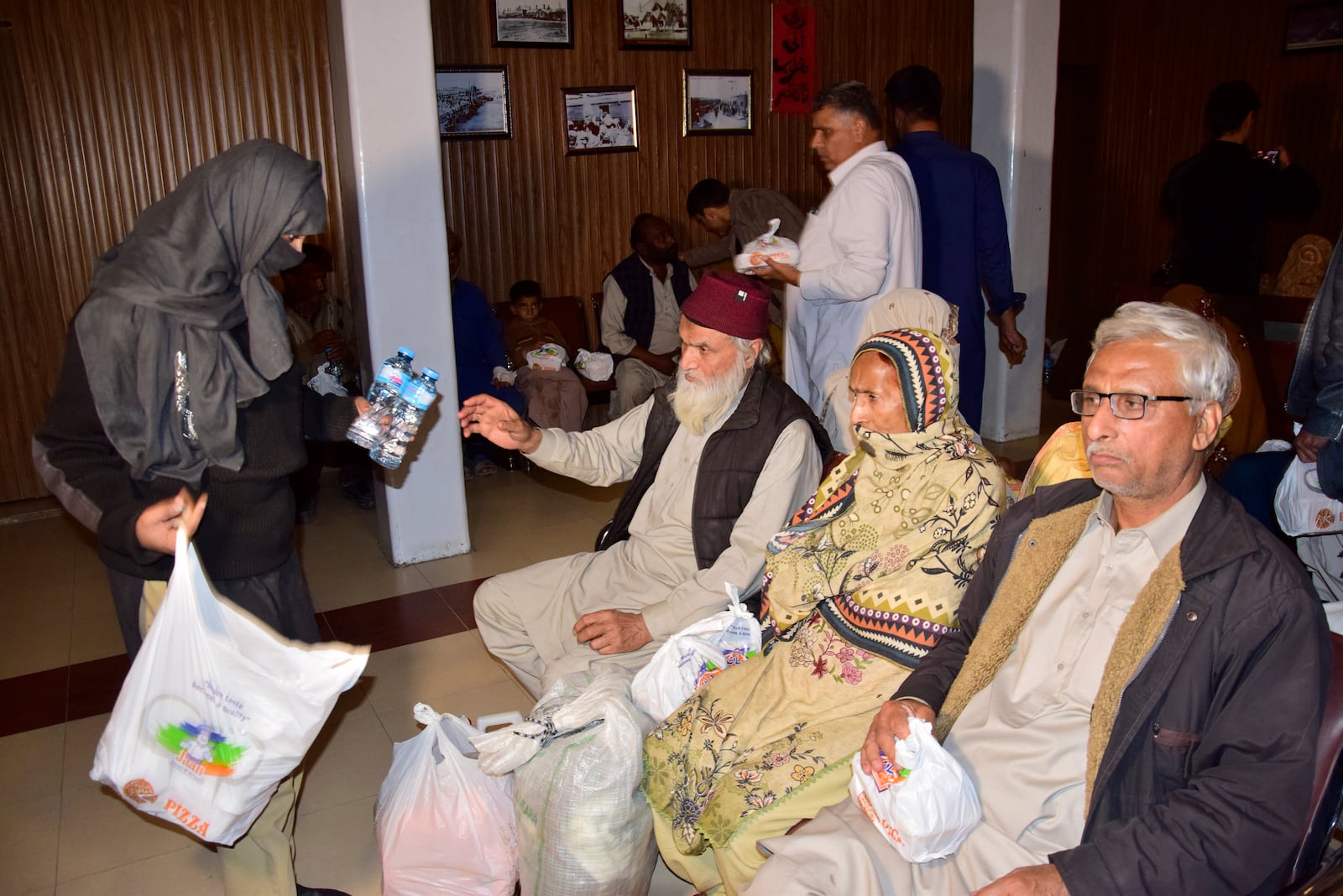 Passengers rescued by security forces from a passenger train attacked by insurgents, receive water bottles upon their arrival at a railway station in Quetta, Pakistan, Wednesday, March 12, 2025. (AP Photo/Arshad Butt)