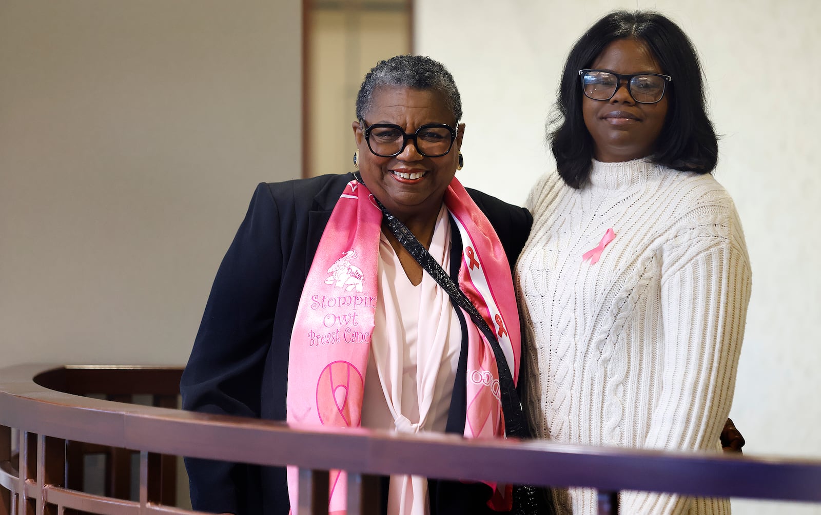 Marva (left) and Kelly Hughes, a mother and daughter from Dayton who are both breast cancer survivors. They were both treated by the same cancer team at Miami Valley Hospital North. MARSHALL GORBY\STAFF