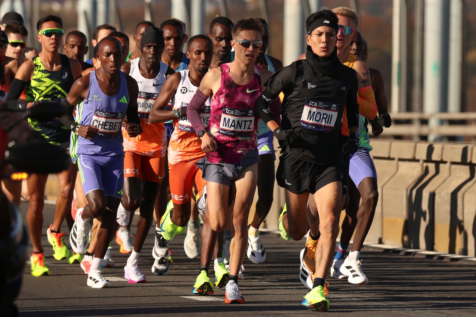 Yuma Morii, of Japan, right, makes his way across the Verrazzano Narrows bridge with the elite men's division runners during the New York City Marathon, Sunday, Nov. 3, 2024, in New York. (AP Photo/Yuki Iwamura)