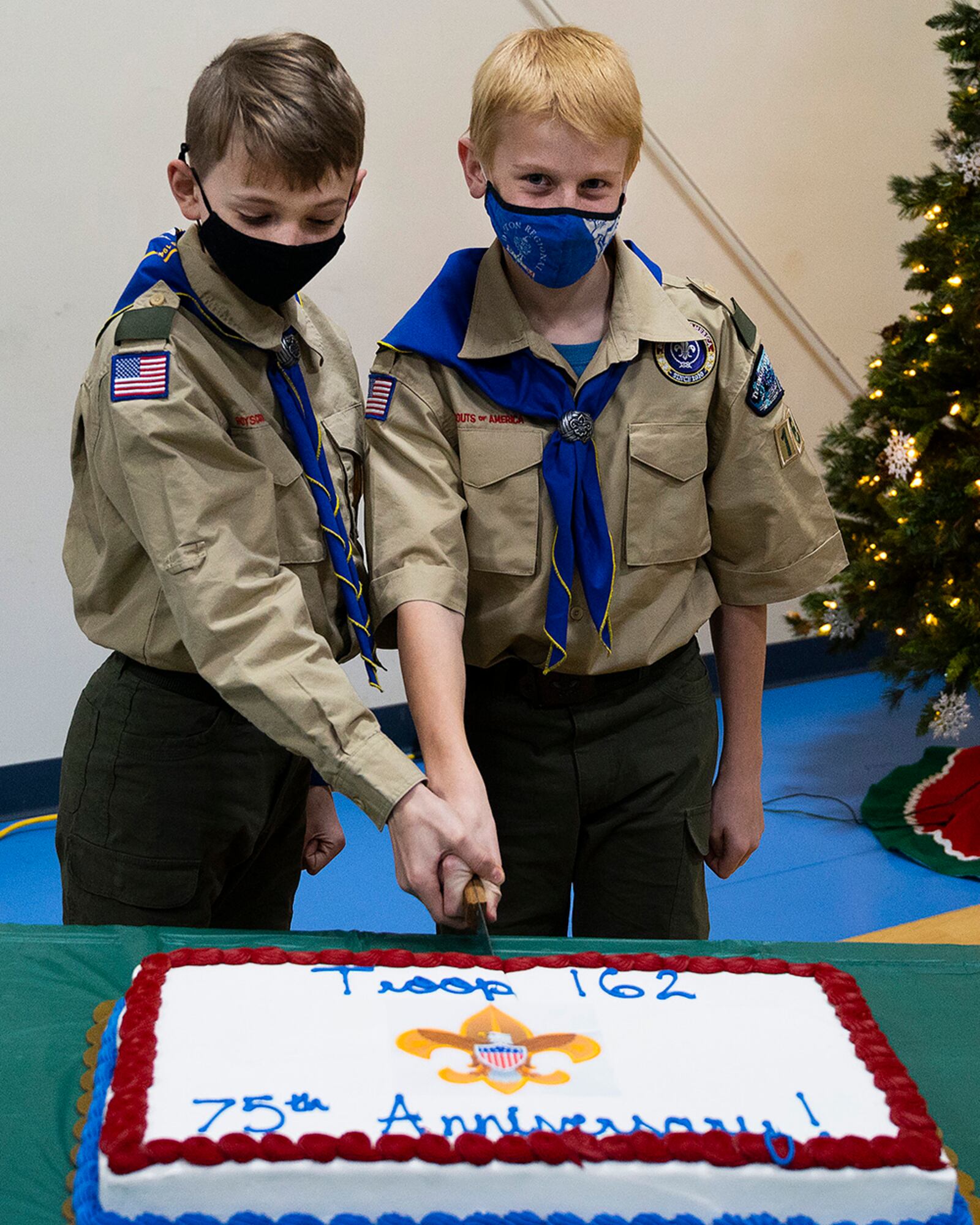 Alexander D’Agostino (left), 11, and Isaiah Hunter, 11, cut a cake commemorating the 75th anniversary of Boy Scout Troop 162 in Fairborn on Dec. 13. Both boys and most others in the troop have a parent attached to, or working at, Wright-Patterson Air Force Base. U.S. AIR FORCE PHOTO/R.J. ORIEZ