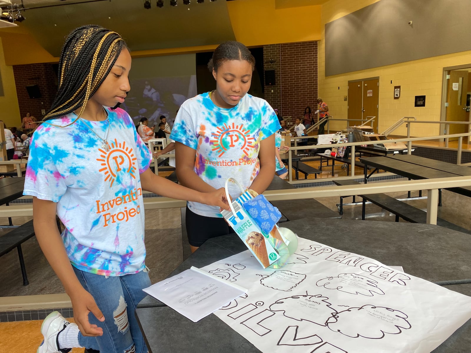 Honesty Booker, left and Variah Pauley, right, show their project during a science fair at Weisenborn Middle School in Huber Heights. Eileen McClory / staff