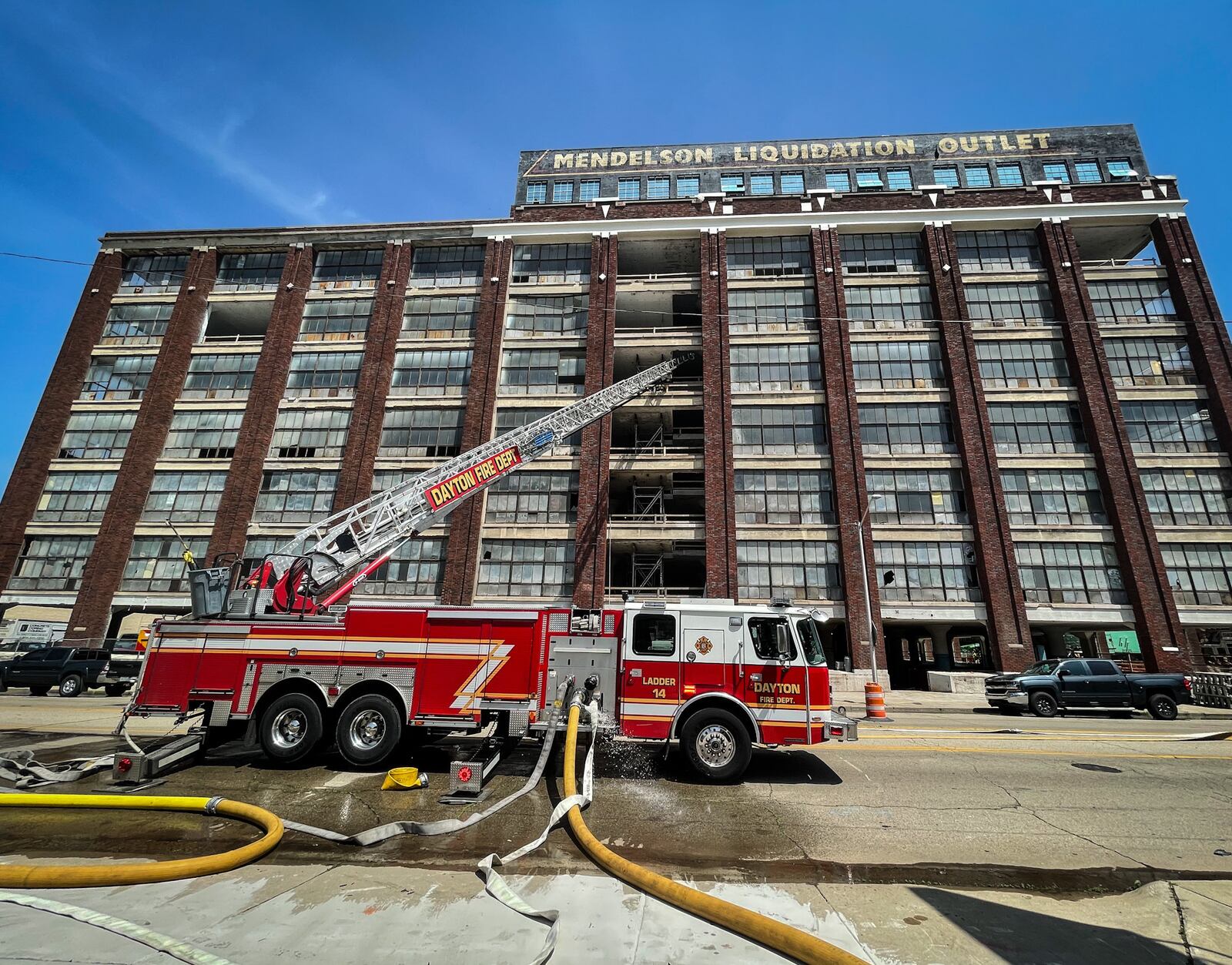 Dayton crews responded to a fire Tuesday morning, June 14, 2022, at the former eight-story Mendelson Liquidation Outlet building in downtown Dayton. JIM NOELKER/STAFF