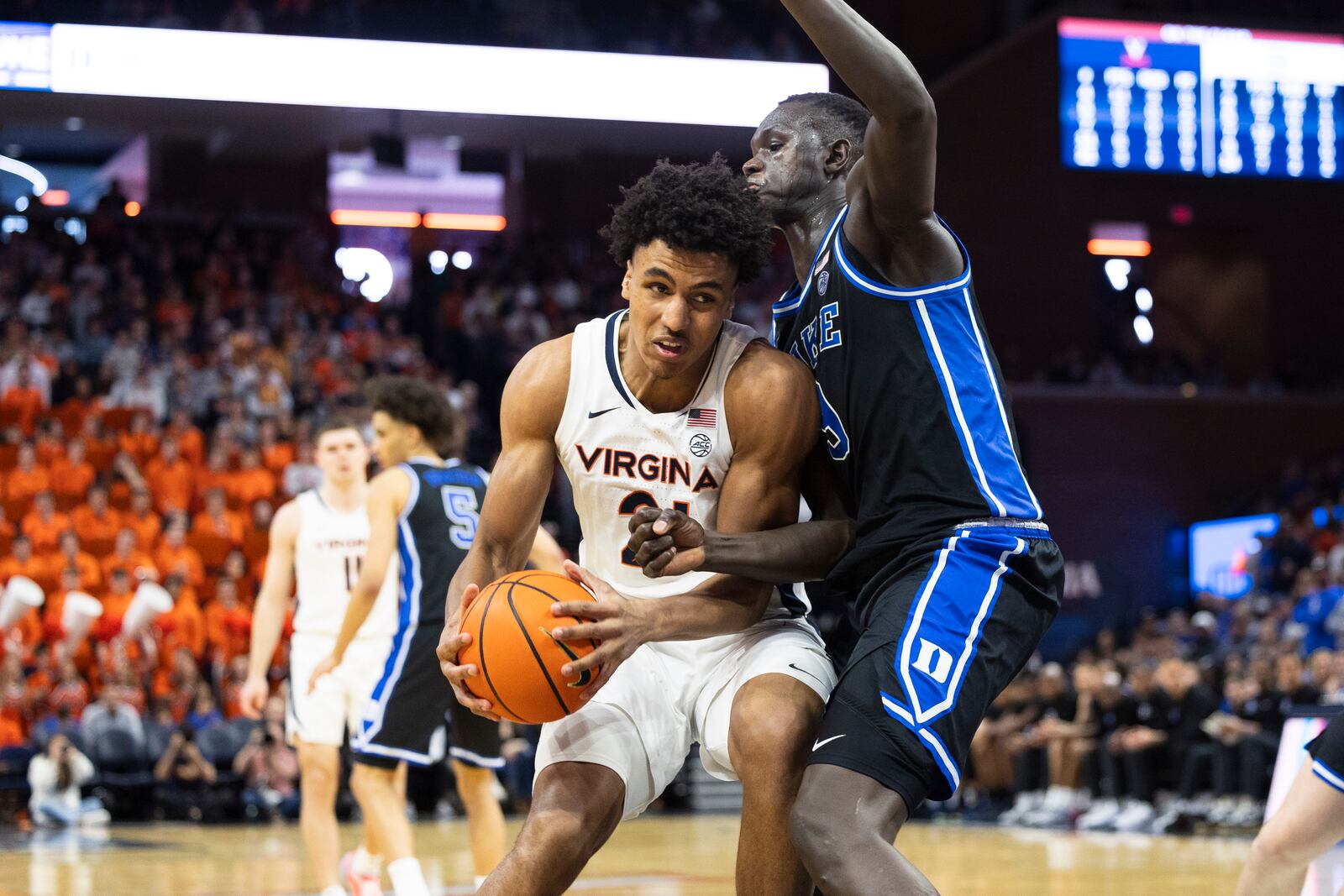 Virginia forward Anthony Robinson defends the ball from Duke center Khaman Maluach during the second half of an NCAA college basketball game, Monday, Feb. 17, 2025, in Charlottesville, Va. (AP Photo/Mike Kropf)