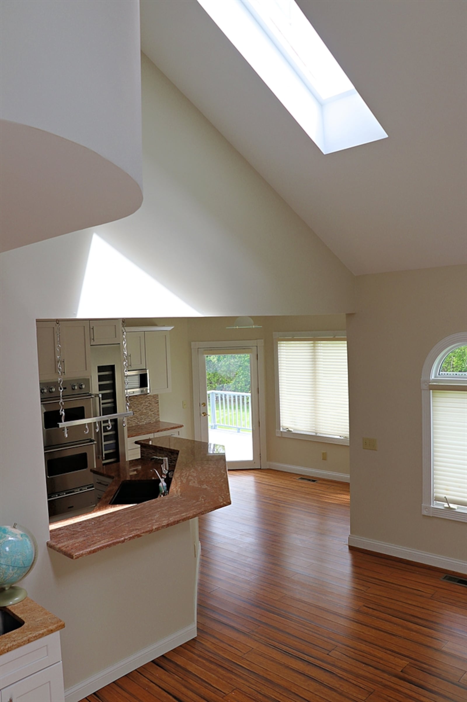 A vaulted ceiling with skylights peaks above the great room.