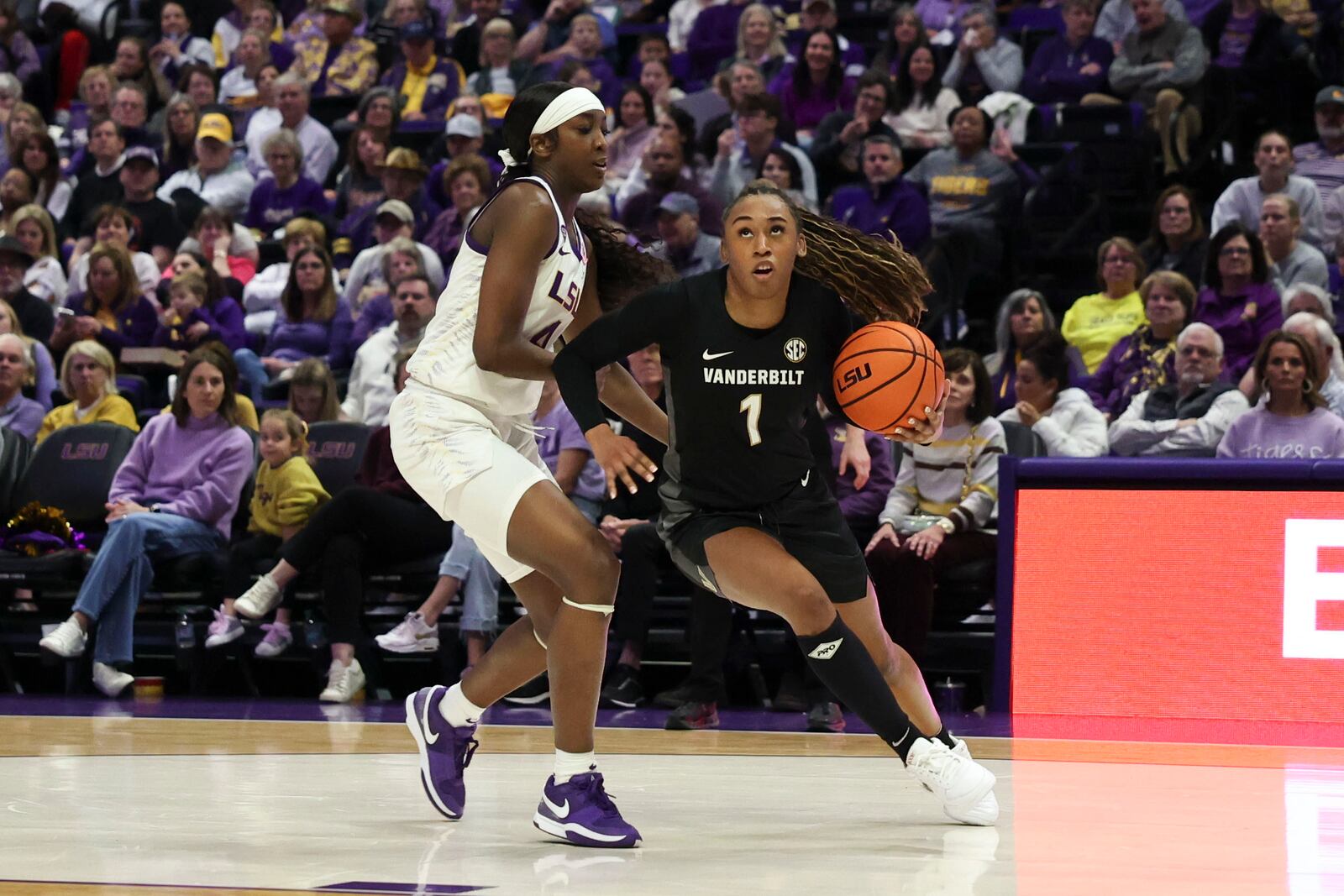 Vanderbilt guard Mikayla Blakes (1) tries to drive past LSU guard Flau'Jae Johnson (4) during the first half of an NCAA college basketball game in Baton Rouge, La., Monday, Jan. 13, 2025. (AP Photo/Peter Forest)